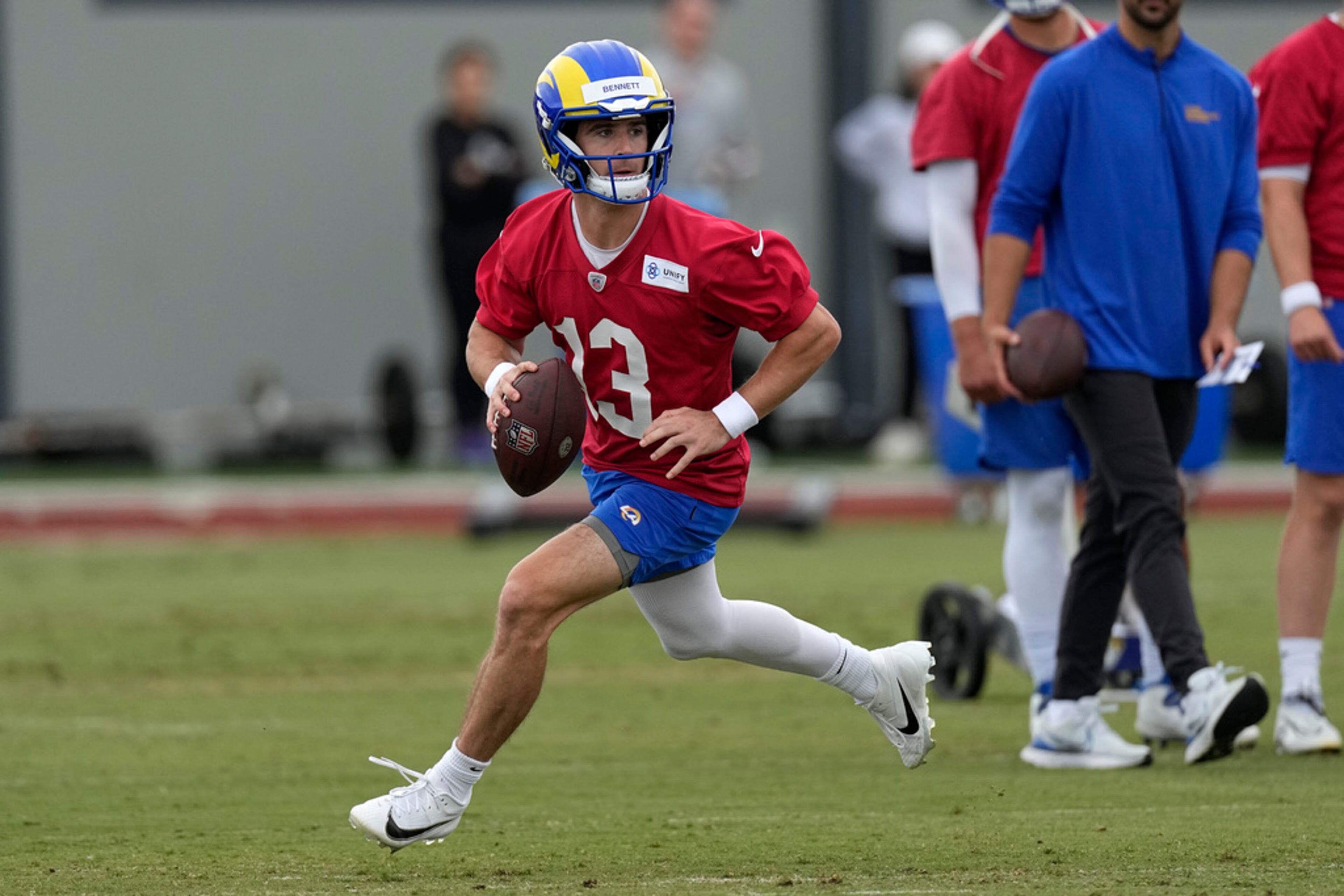 Former Georgia quarterback Stetson Bennett, now playing for Los Angeles Rams, rolls out to pass during the NFL football team's organized activities Wednesday, May 31, 2023, in Thousand Oaks, Calif. (AP Photo/Mark J. Terrill)
