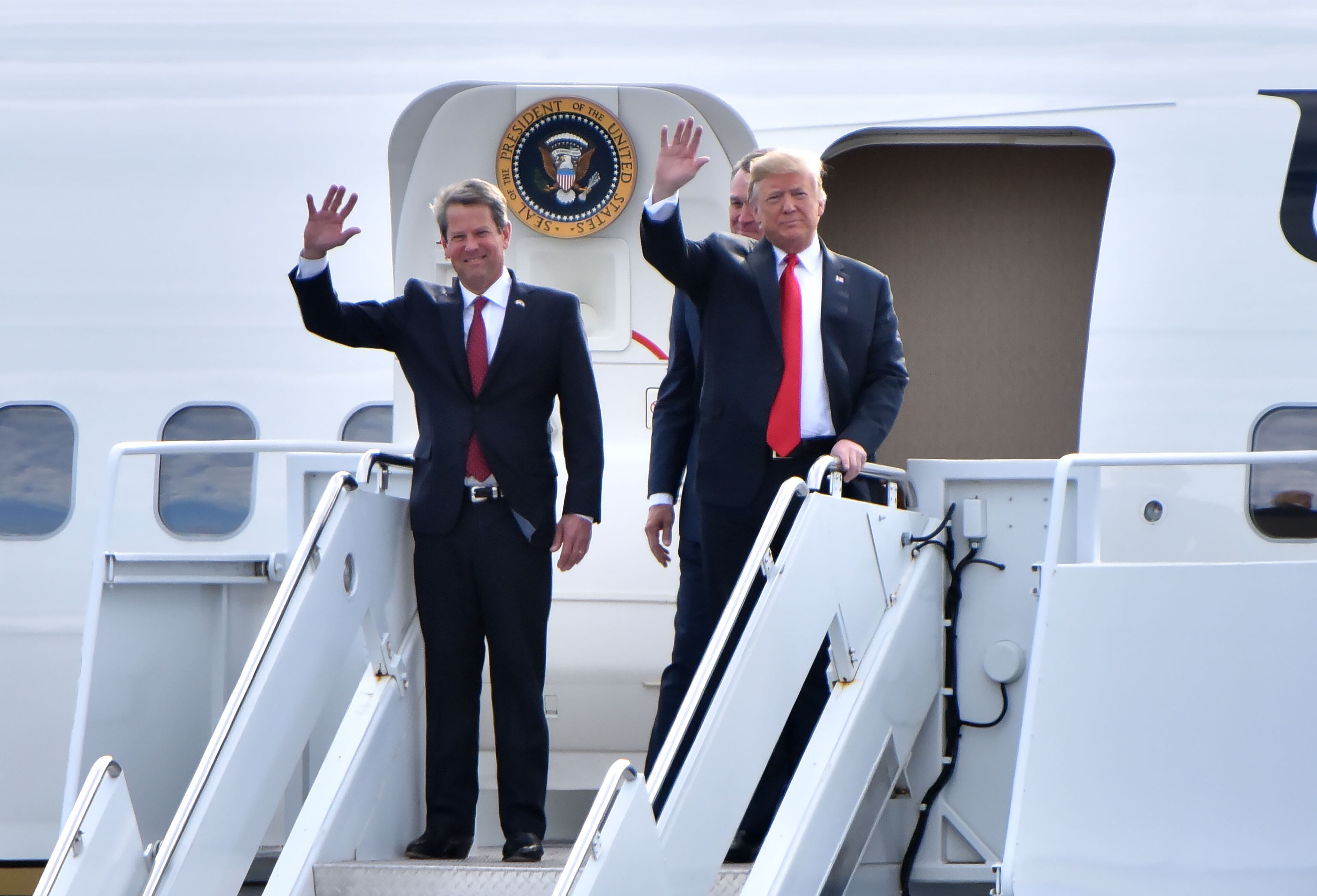 November 4, 2018 Macon - GOP gubernatorial candidate Brian Kemp and President Donald Trump wave from Air Force One as President Donald J. Trump arrives during President Donald J. Trump's Make America Great Again Rally to support Brian Kemp at Middle Georgia Regional Airport in MaconSunday, November 4, 2018. HYOSUB SHIN / HSHIN@AJC.COM