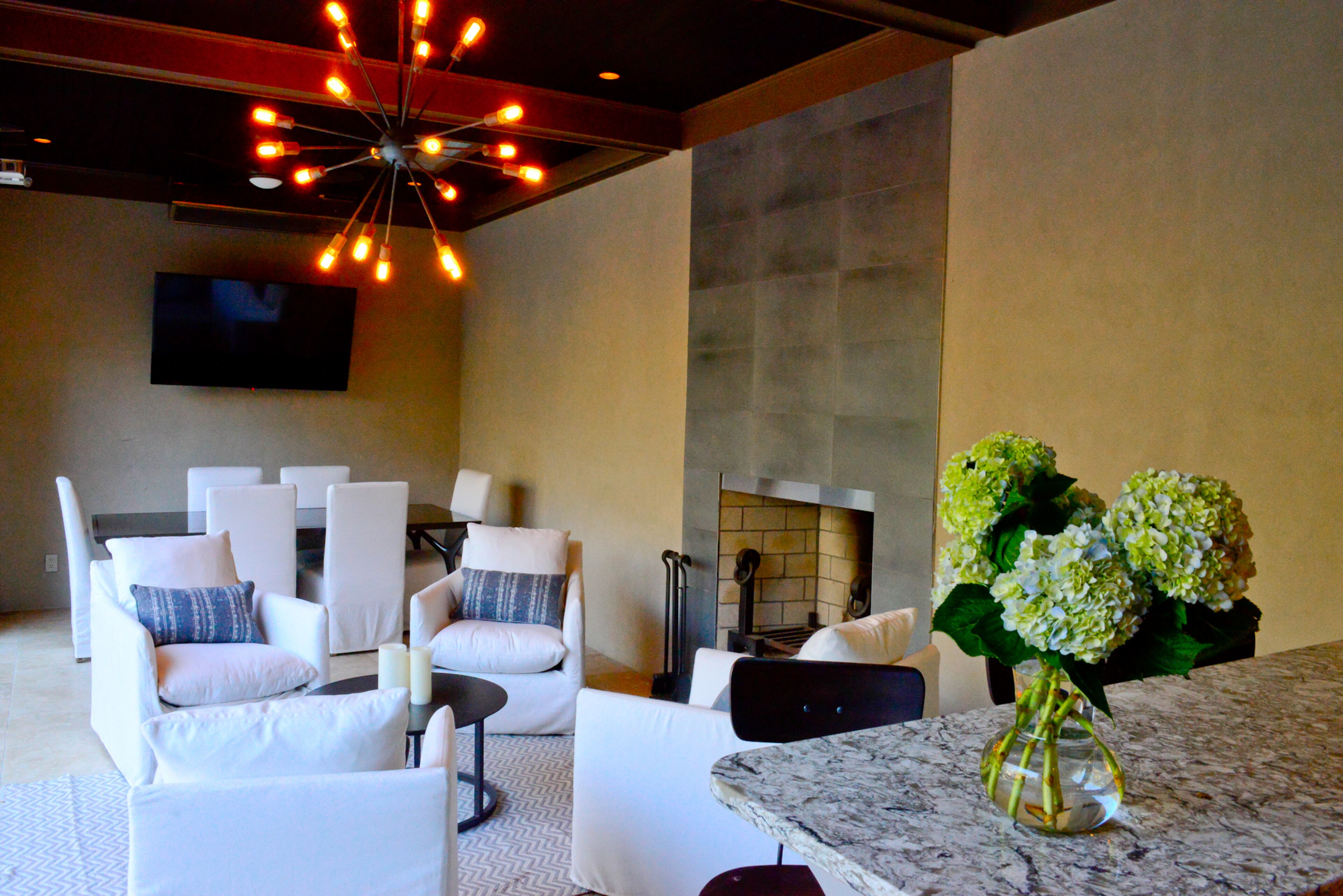 The pool cabana is designed for entertaining year round. The family often watches sports and movies outside, since the cabana is equipped with a dropdown screen, projection system and two TVs.