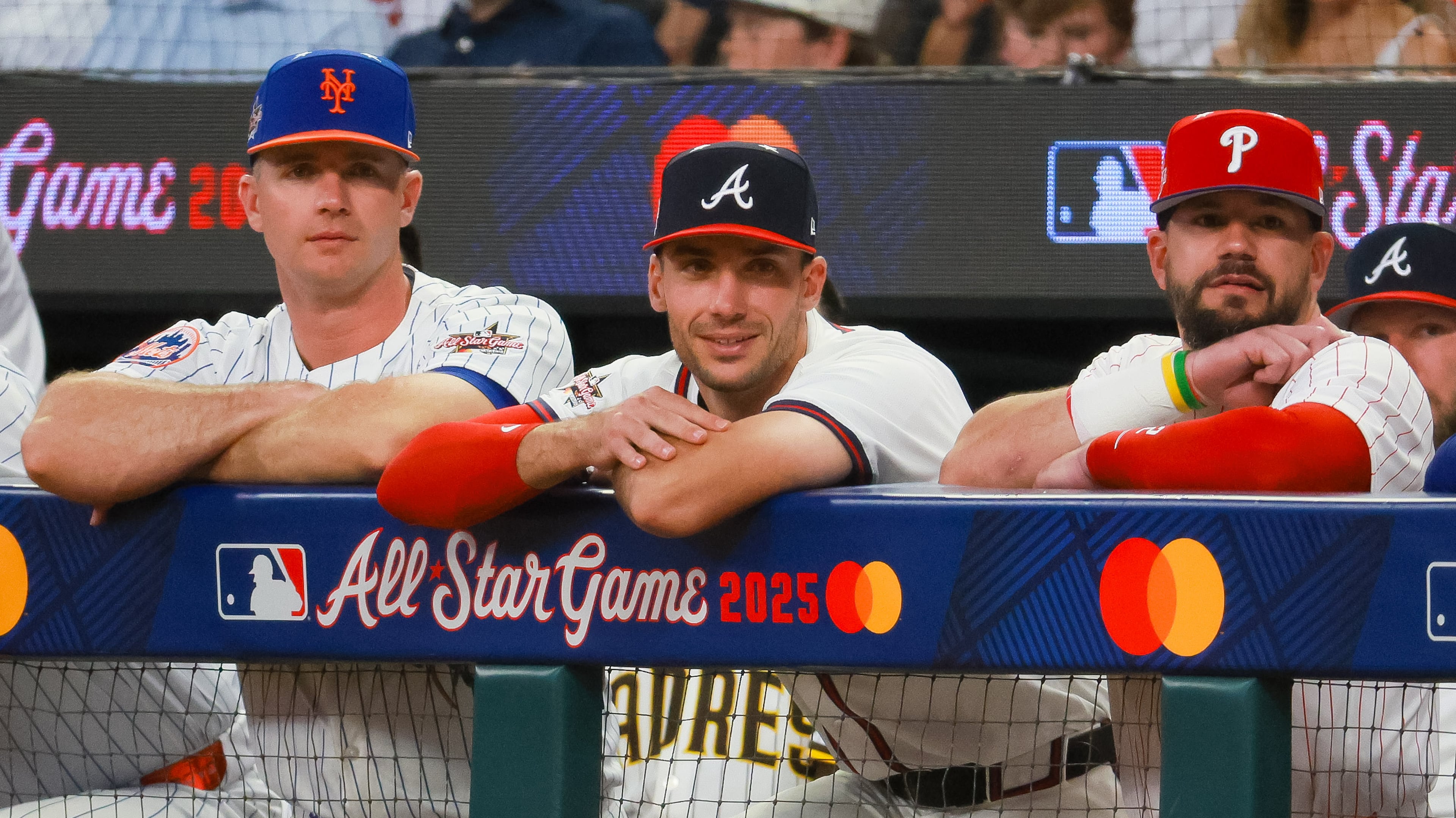 The National League's Matt Olson of the Atlanta Braves (center) stands between Pete Alonso of the New York Mets (left) and Kyle Schwarber of the Philadelphia Phillies (right) during the second inning of the MLB All-Star Game at Truist Park in Atlanta. (Jason Getz/AJC 2025)