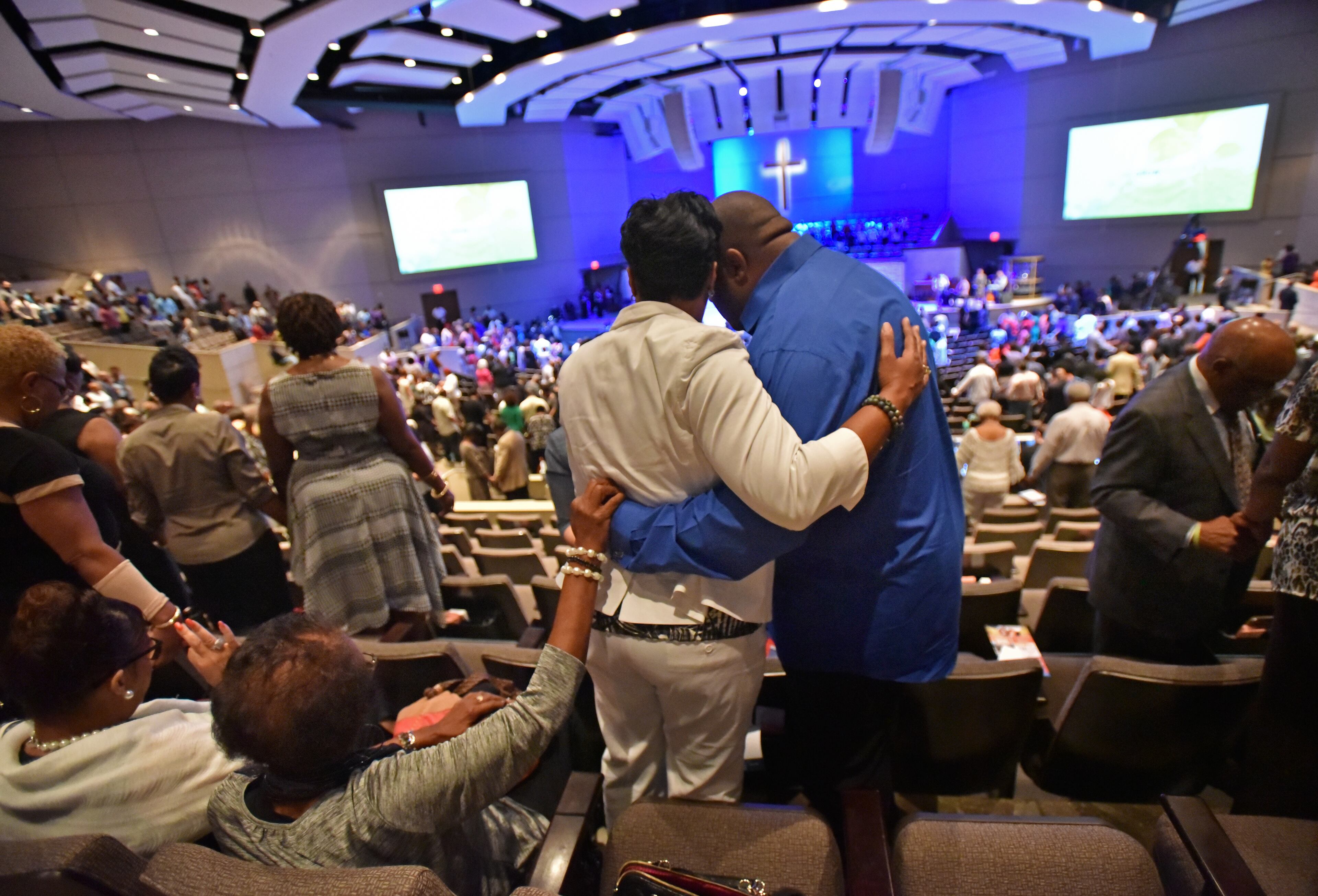 July 10, 2016 Dallas, Texas - Church members join hands as they take part in a service at Concord Church in Dallas on Sunday, July 10, 2016. HYOSUB SHIN / HSHIN@AJC.COM