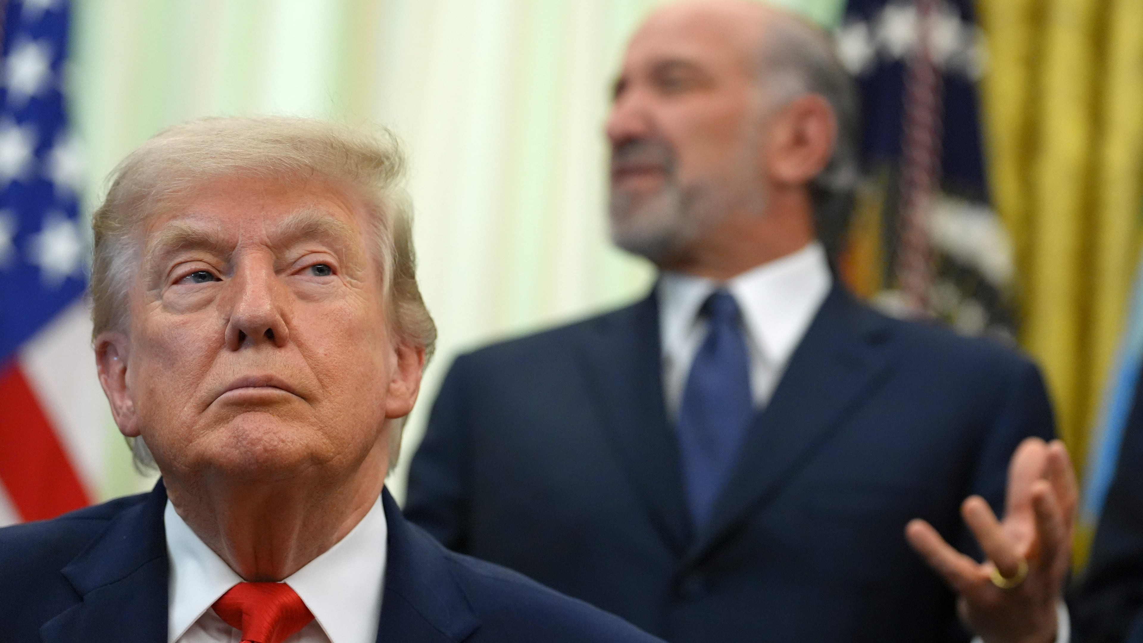 Commerce Secretary Howard Lutnick speaks before President Donald Trump, in foreground, signs a proclamation about the fishing industry, in the Oval Office of the White House, Thursday, June 11, 2026, in Washington. (AP Photo/Jacquelyn Martin)
