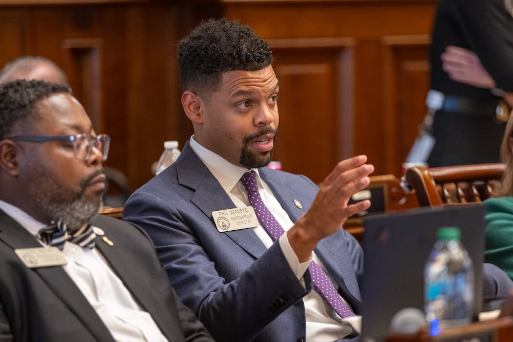 State Rep. Phil Olaleye, center, seen here at the state Capitol in 2025. (Arvin Temkar/AJC)