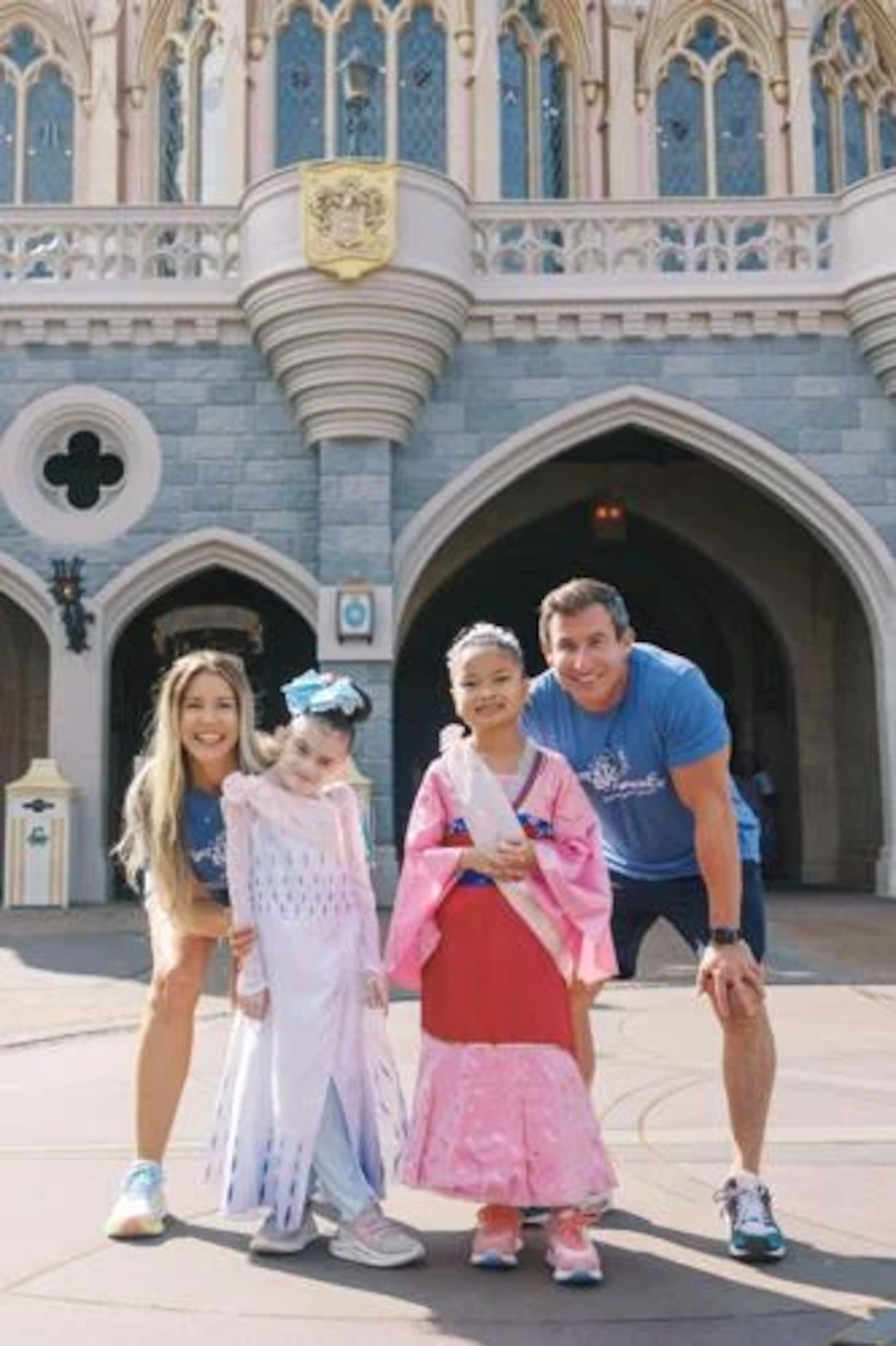 From left, "The Bert Show" member Kristin Klinghorn, Dakota, Layla and Bert Weiss pose before the castle at Disney's Magic Kingdom. (Courtesy of Bert's Big Adventure)