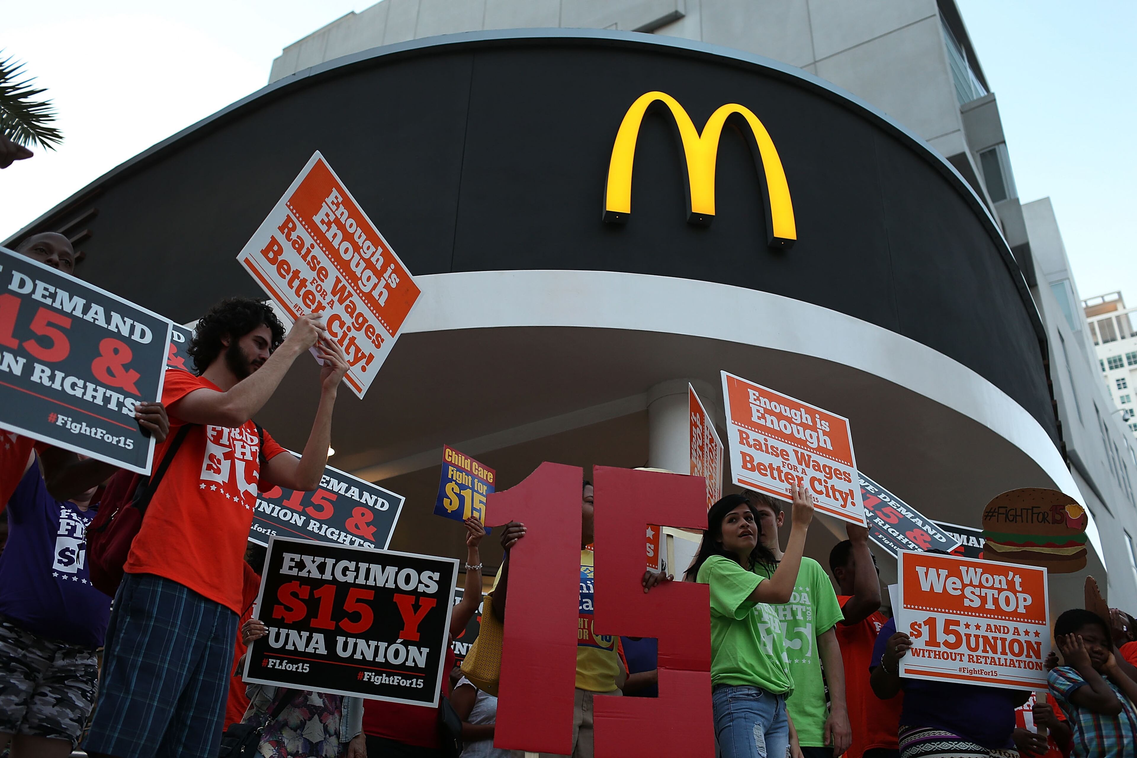 MIAMI, FL - NOVEMBER 10: Workers protest outside a McDonald's restaurant on November 10, 2015 in Miami, Florida. The protesters are demanding action from state legislators and presidential candidates to raise the minimum wage to $15 an hour. (Photo by Joe Raedle/Getty Images)
