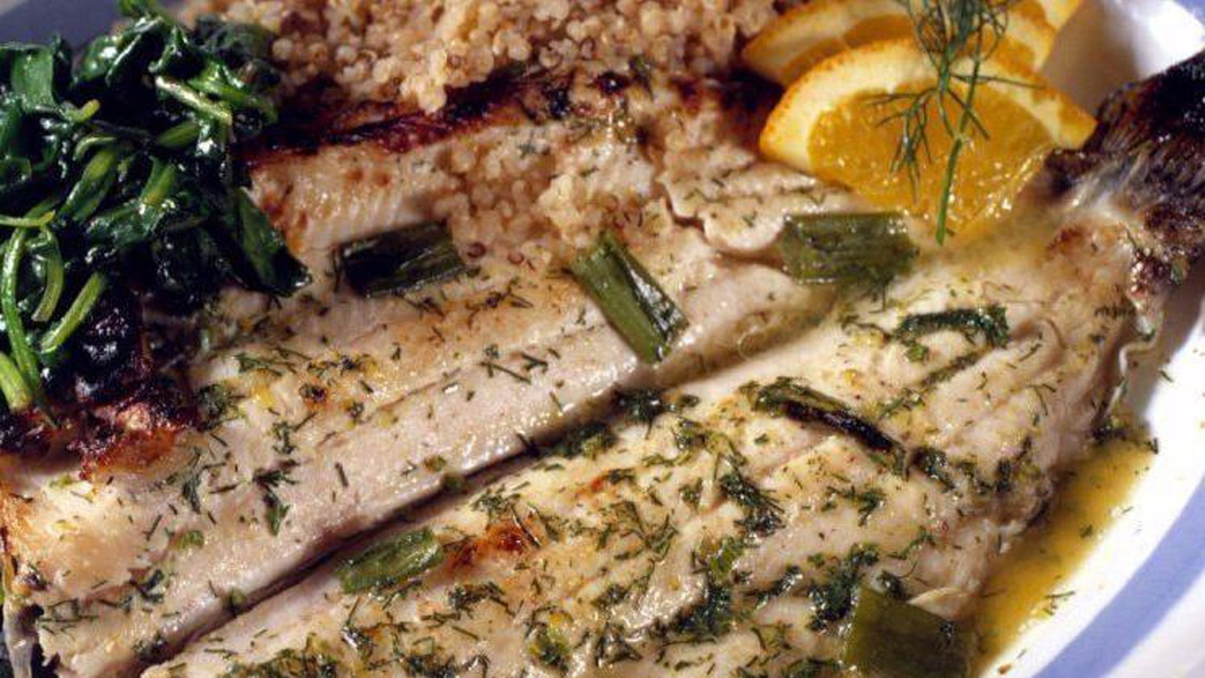 Orange juice and dry vermouth create a braising liquid for trout fillets, which are then finished in the oven. (Chicago Tribune/TNS)