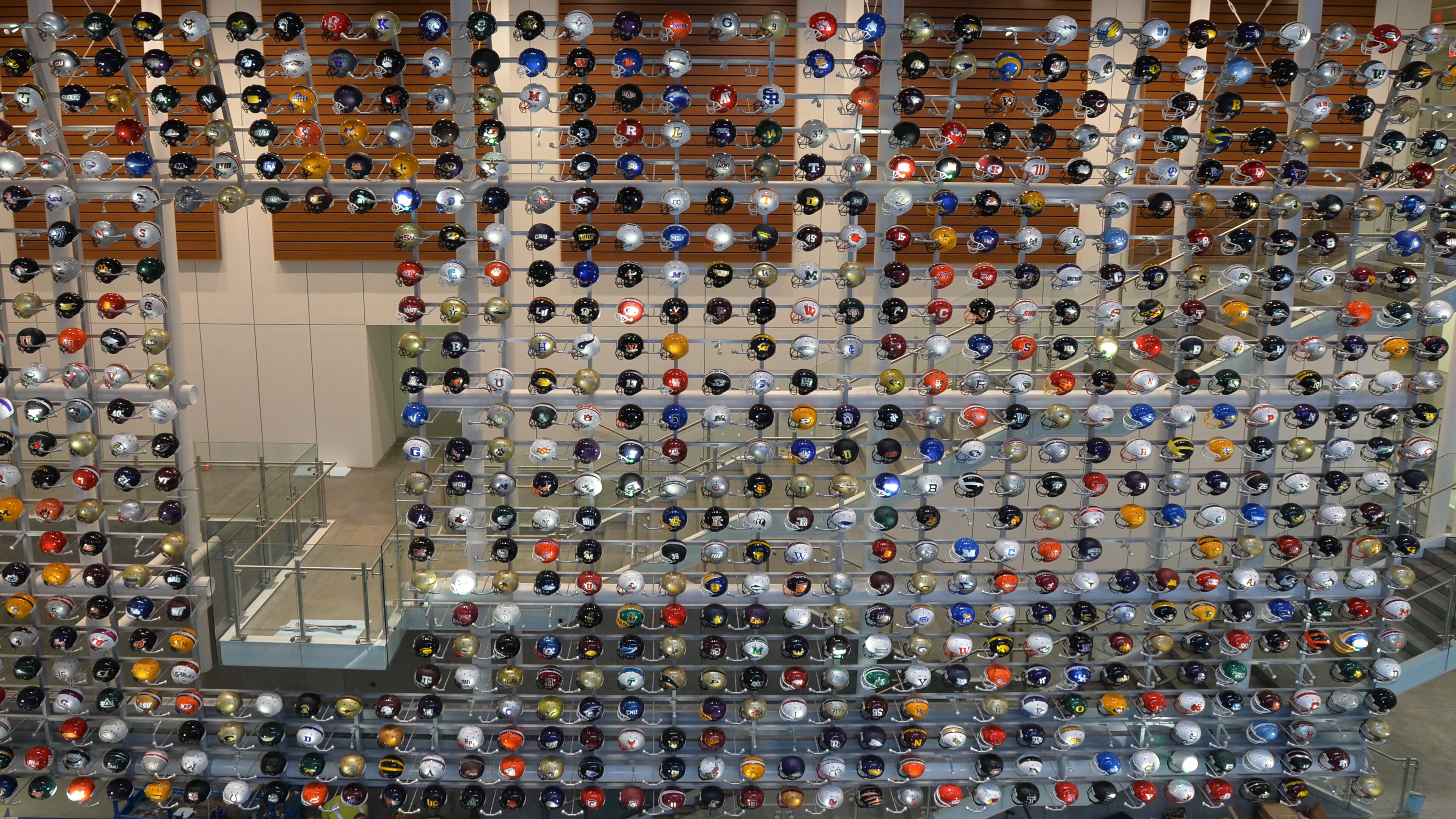 A wall of helmets greets fans at the College Football Hall of Fame. (AJC file photo by Brant Sanderlin)