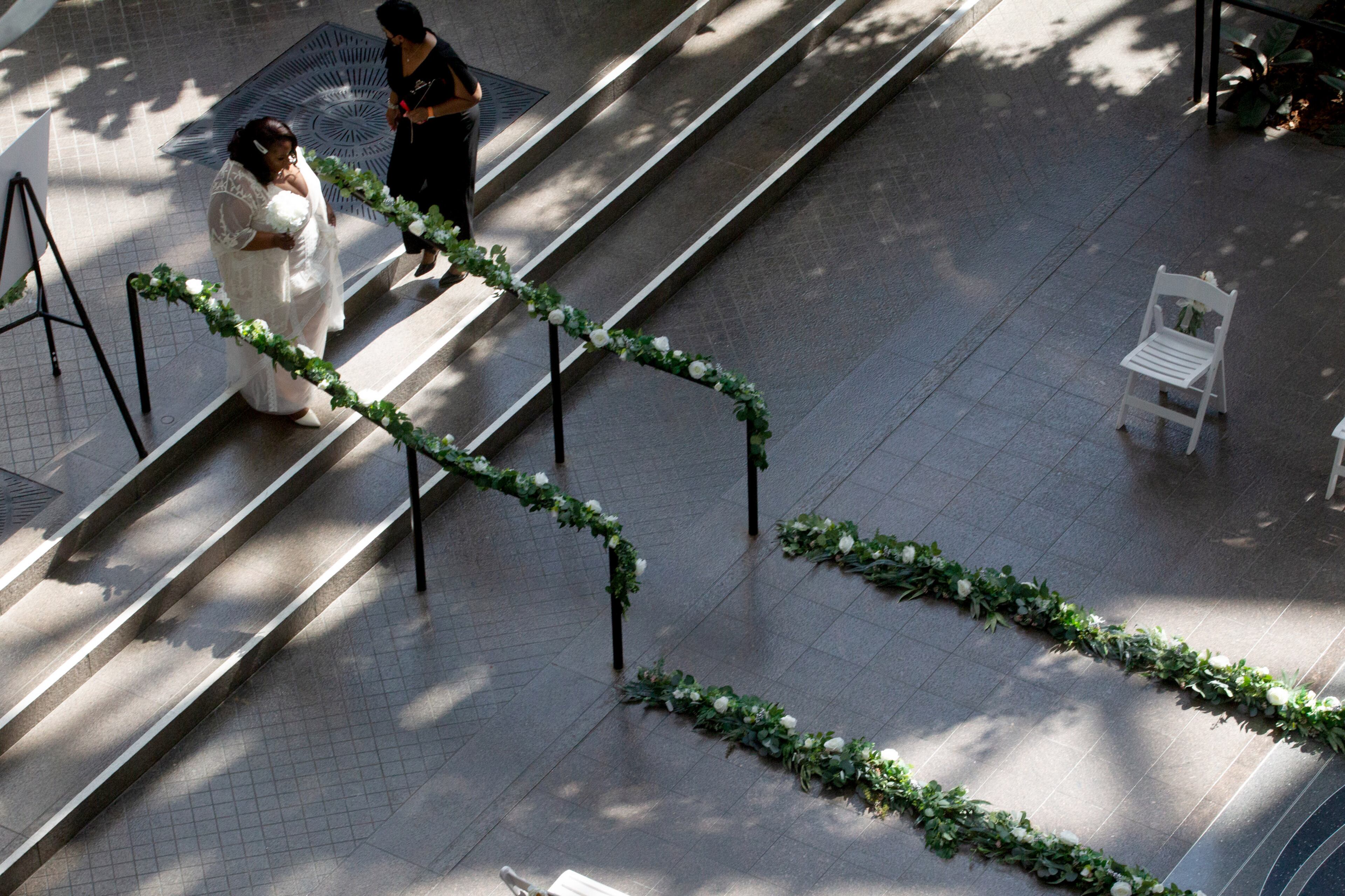 A bride waits to walk down the aisle at the start of her wedding ceremony in the Atrium of the Fulton County Building Auth. on valentines day, February 14, 2022. STEVE SCHAEFER FOR THE ATLANTA JOURNAL-CONSTITUTION STEVE SCHAEFER FOR THE ATLANTA JOURNAL-CONSTITUTION