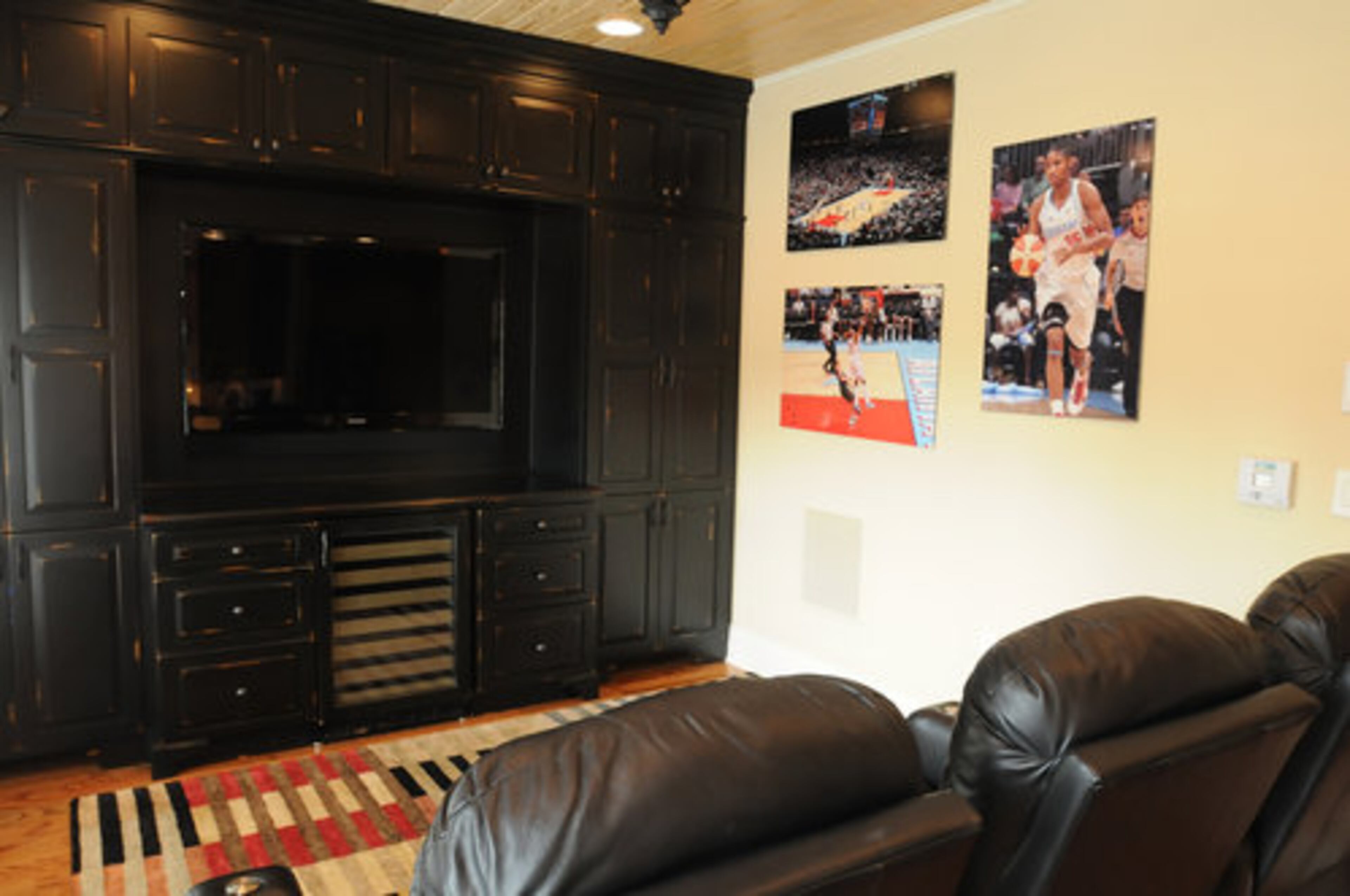 The fourth-floor media room is outfitted with black leather recliners and a 60-inch TV, the home's largest.