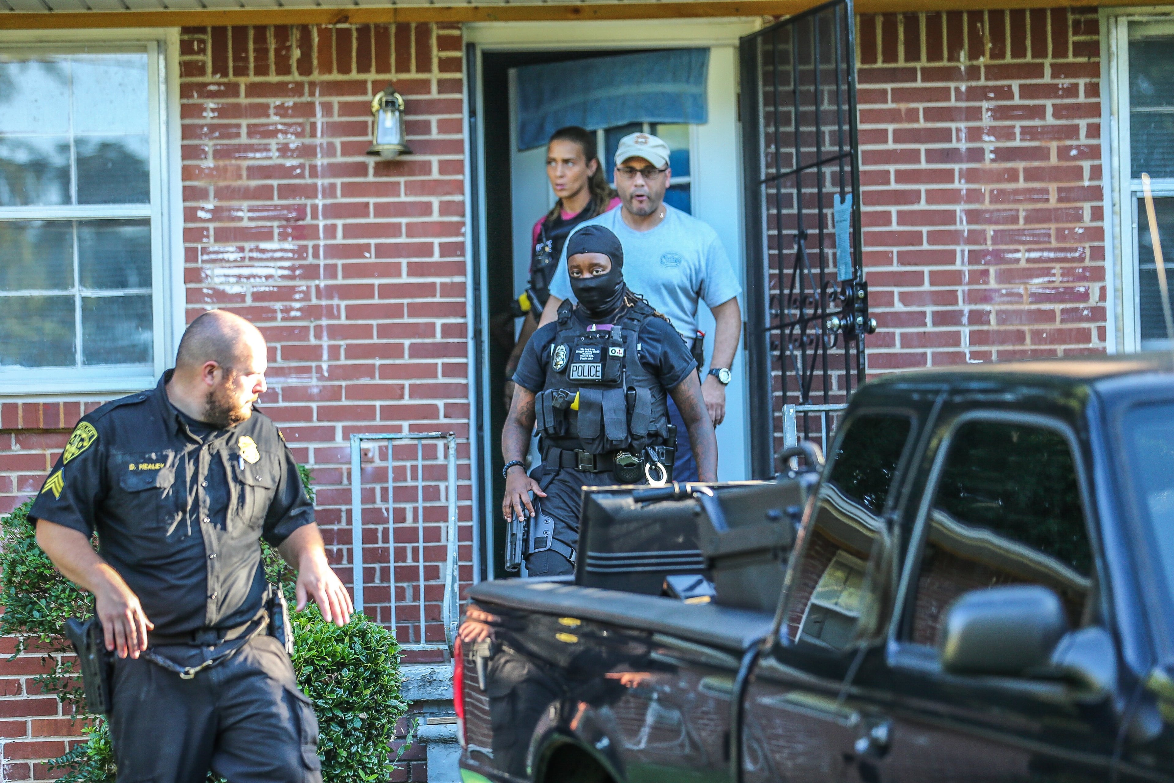 Officers seized cash, suspected drugs, guns and electronics from the Ocean Valley Road home on Friday morning.