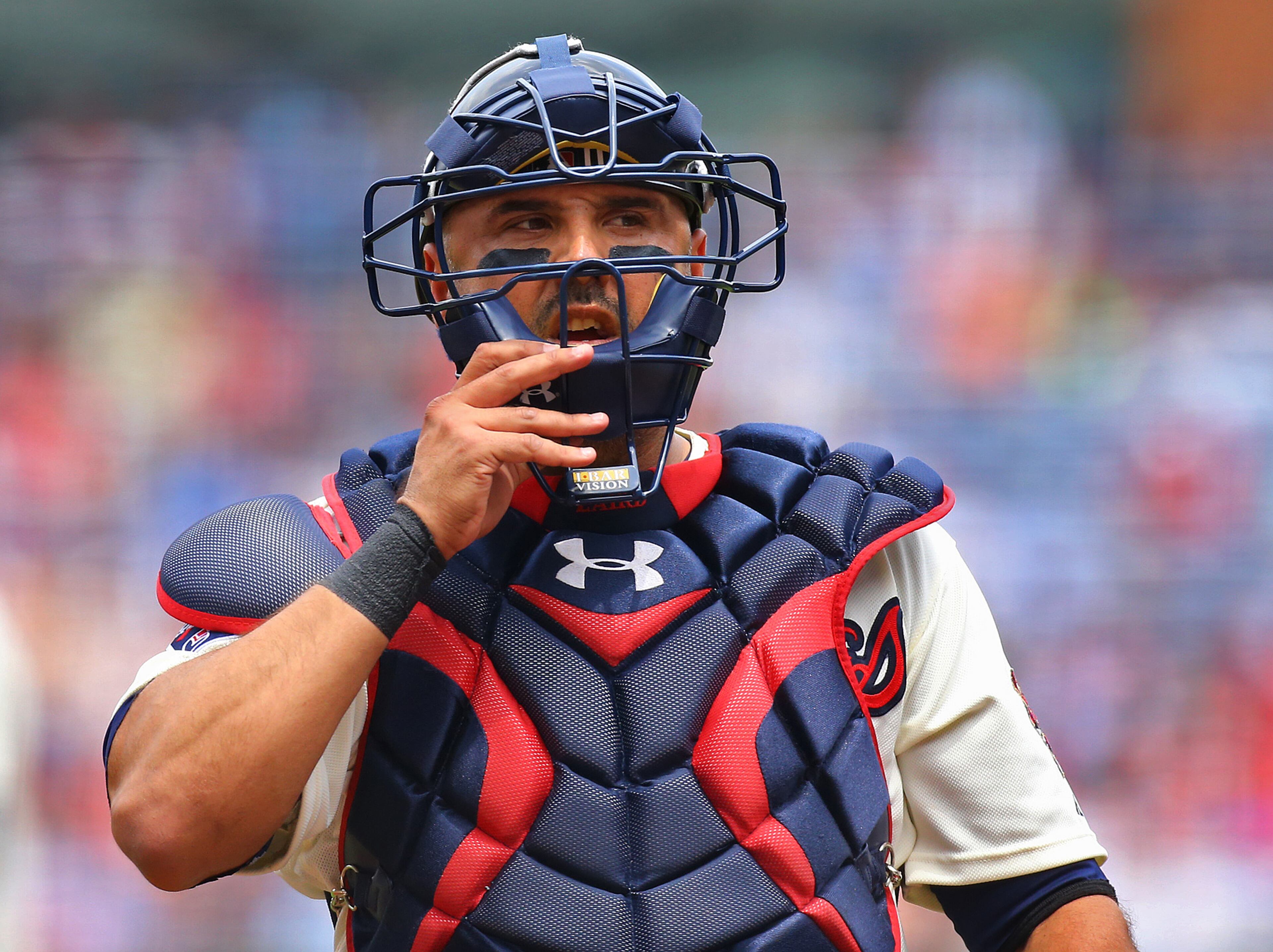 Braves catcher Gerald Laird adjusts his headgear during the first inning against the Reds on Sunday, April 27, 2014, in Atlanta. CURTIS COMPTON / CCOMPTON@AJC.COM