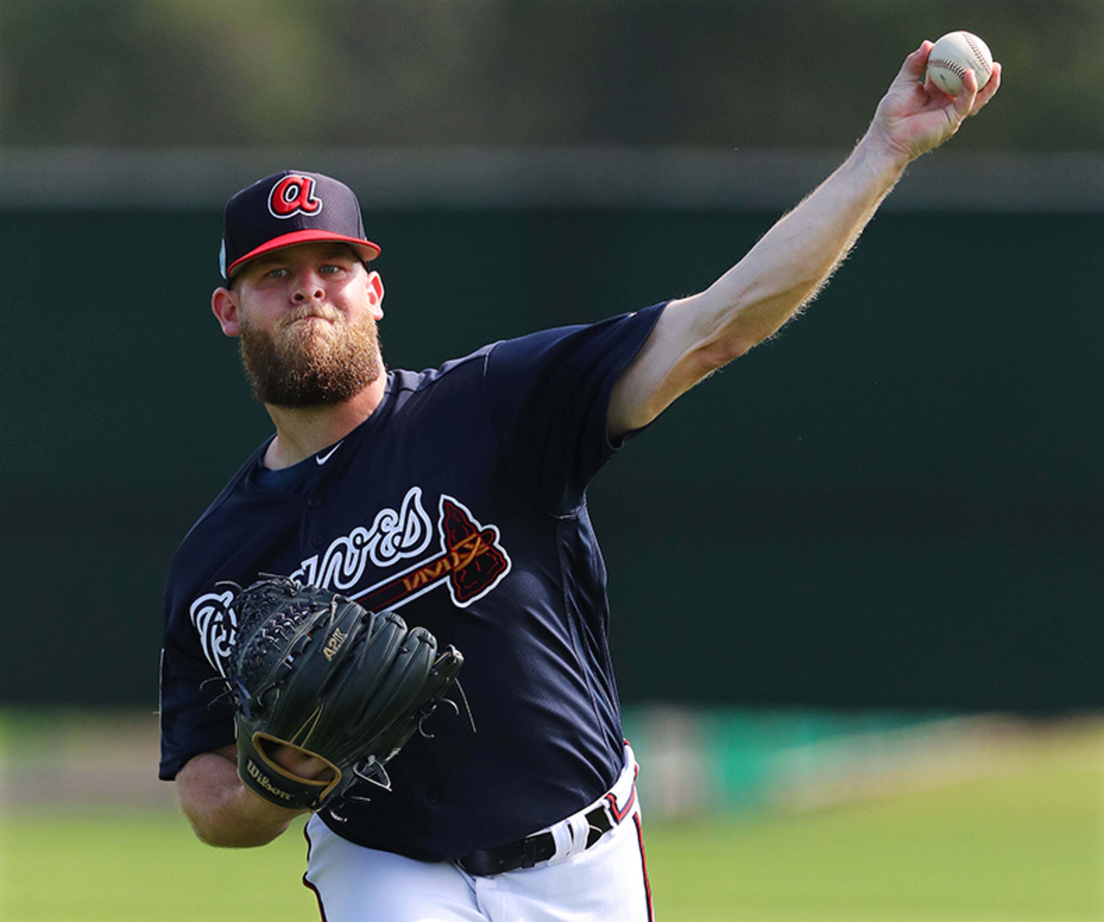 Atlanta Braves pitcher A.J. Minter loosens up his arm throwing in the field during spring training Tuesday, Feb. 19, 2019, at the ESPN Wide World of Sports Complex in Lake Buena Vista, Fla.