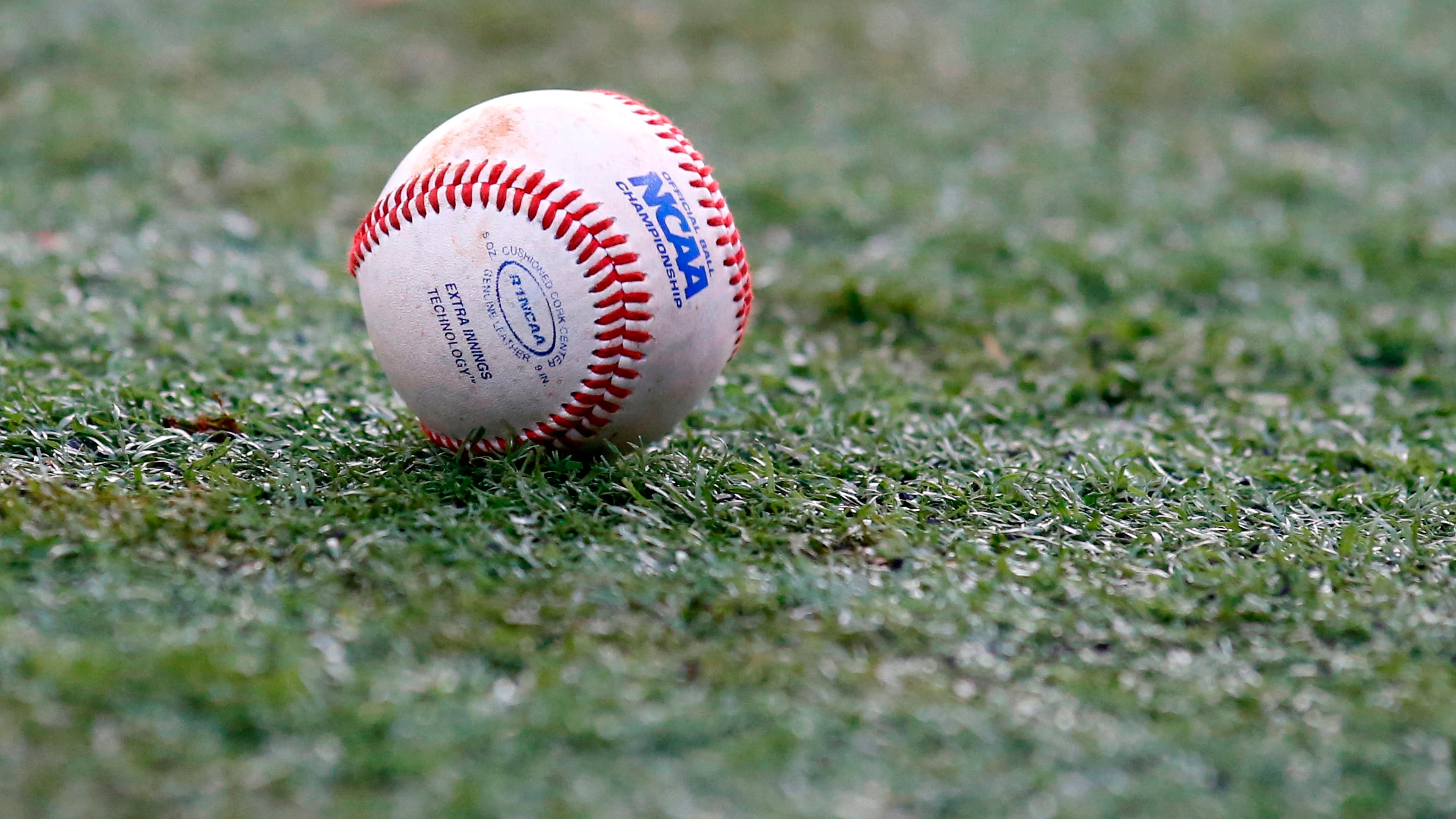 FILE - The NCAA logo is seen on a baseball during an NCAA college baseball tournament regional game between Louisiana-Lafayette and Mississippi State in Lafayette, La., June 2, 2014. (AP Photo/Jonathan Bachman, File)