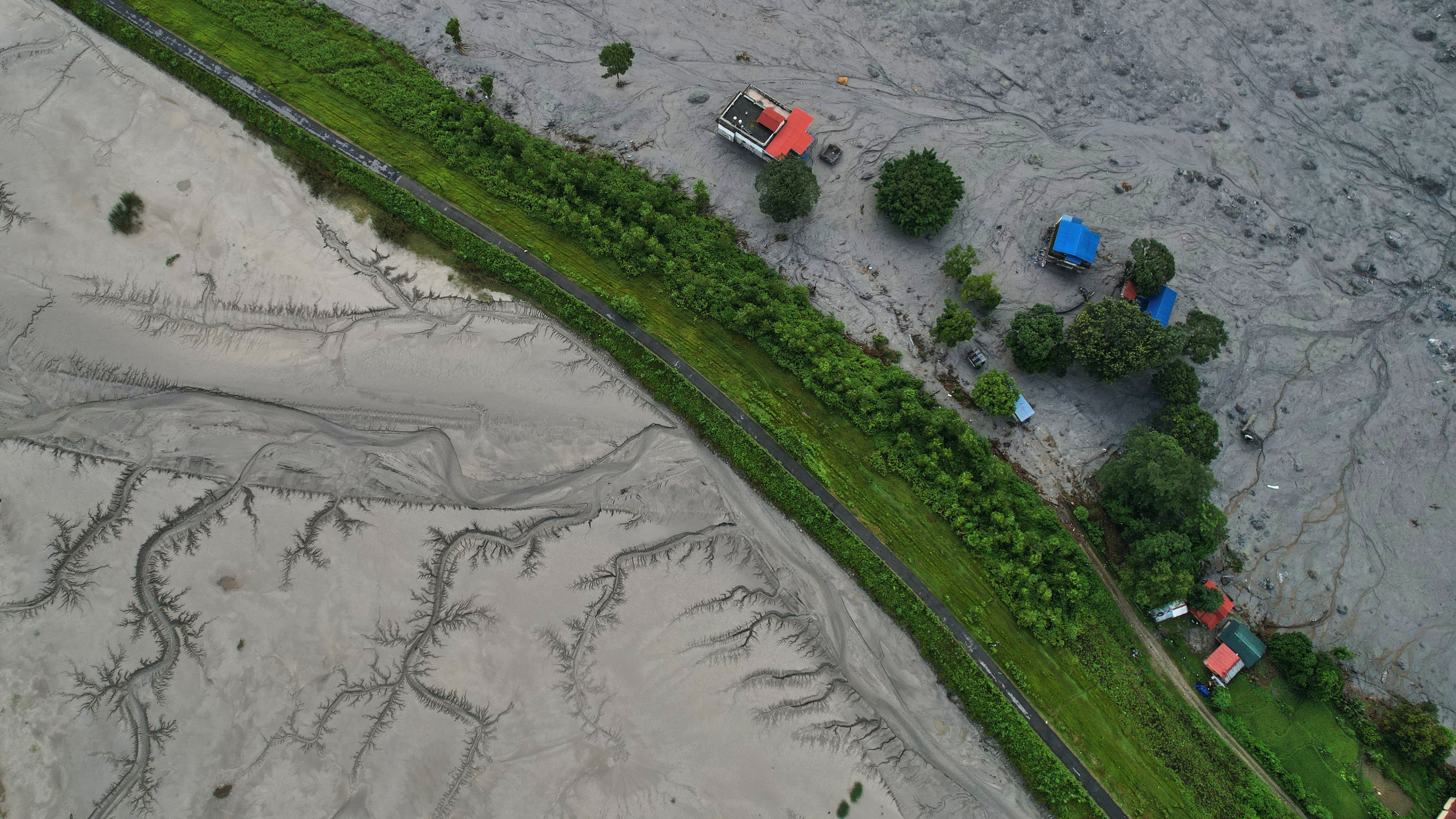 A drone view shows a major section of Pasang Lhamu highway washed away along swollen Trishuli river by recent flash floods cutting off Rasuwa district from Nuwakot area, Nepal, Monday, Aug. 31, 2026. (AP Photo/Rajesh Kumar Singh)