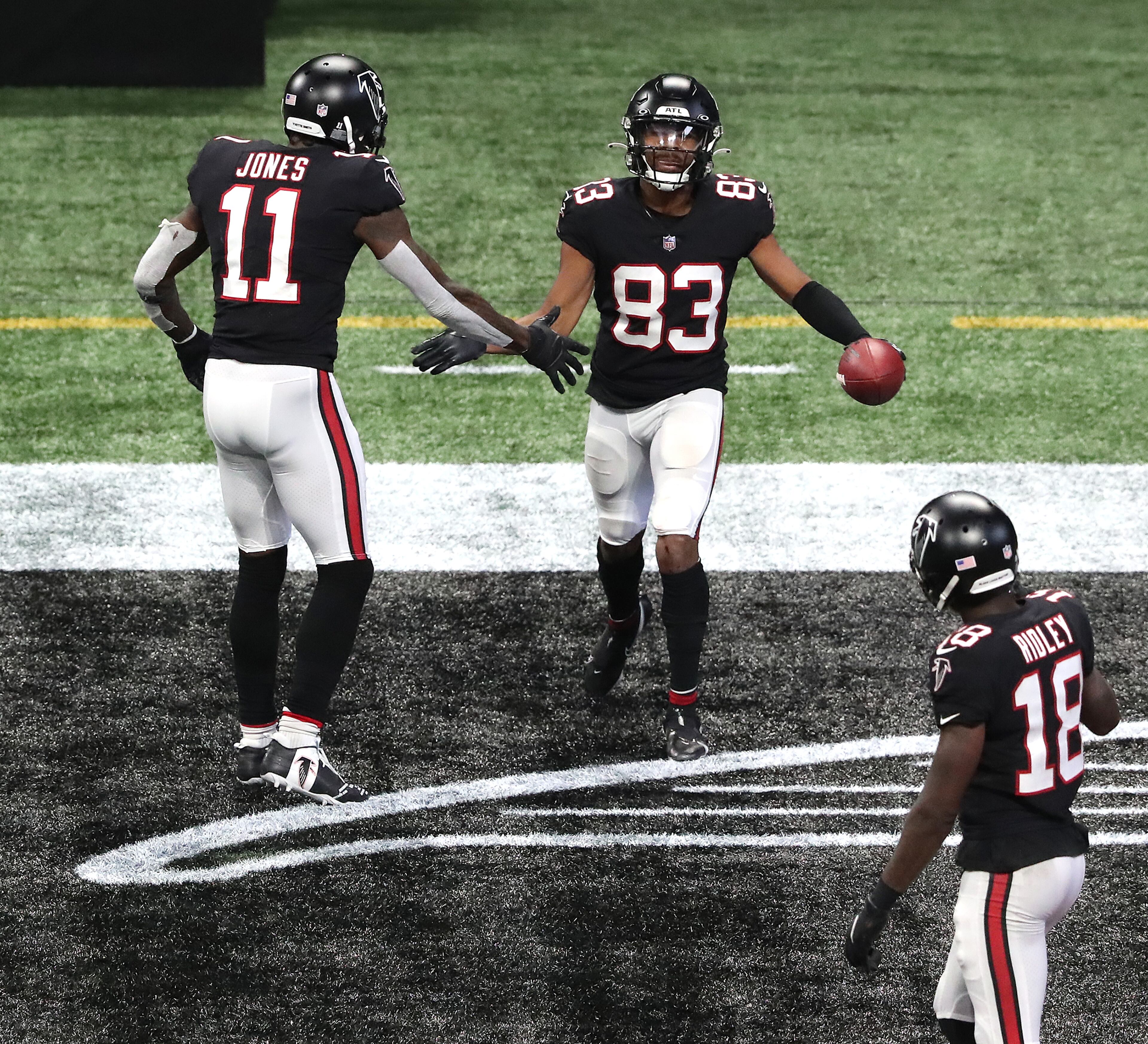 Falcons wide receiver Russell Gage is congratulated by teammates Julio Jones (11) and Calvin Ridley (18) after his touchdown reception cut the New Orleans Saints' lead to 21-16 during the fourth quarter Sunday, Dec. 6, 2020, at Mercedes-Benz Stadium in Atlanta. (Curtis Compton / Curtis.Compton@ajc.com)