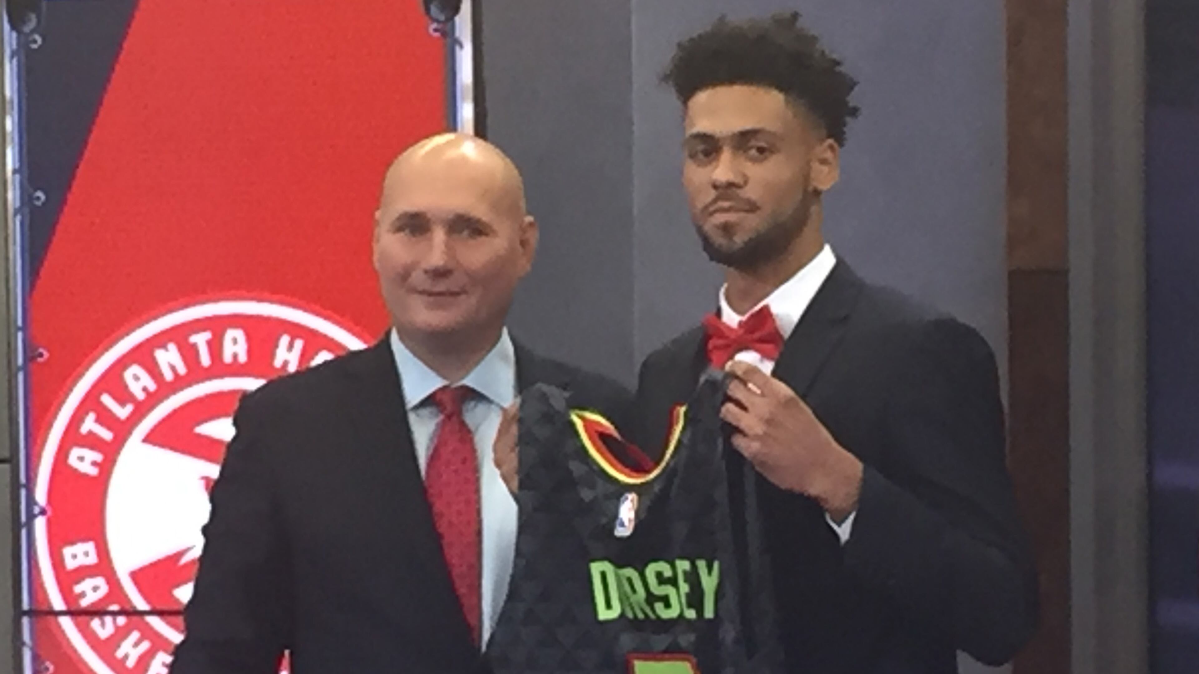 Tyler Dorsey (right) and Hawks general manager Travis Schlenk unveil his jersey at an introductory press conference on Monday. Photo by Chris Vivlamore