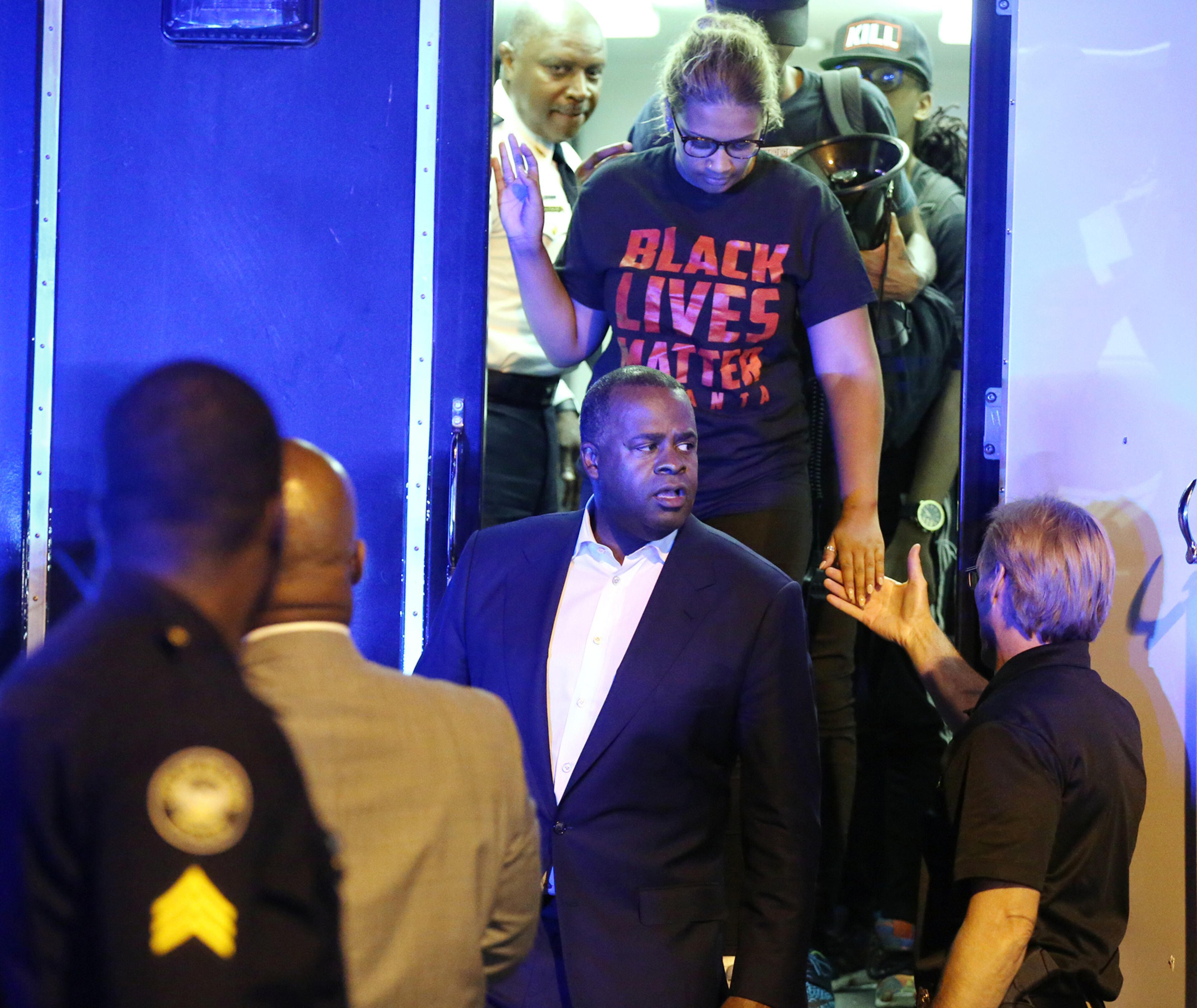 071016 ATLANTA: Atlanta Mayor Kasim Reed and Chief of Police George Turner leave a command vehicle with protest leaders after meeting with them outside the Governor's mansion during a fifth night of demonstrations on Monday, July 11, 2016, in Atlanta. Curtis Compton /ccompton@ajc.com