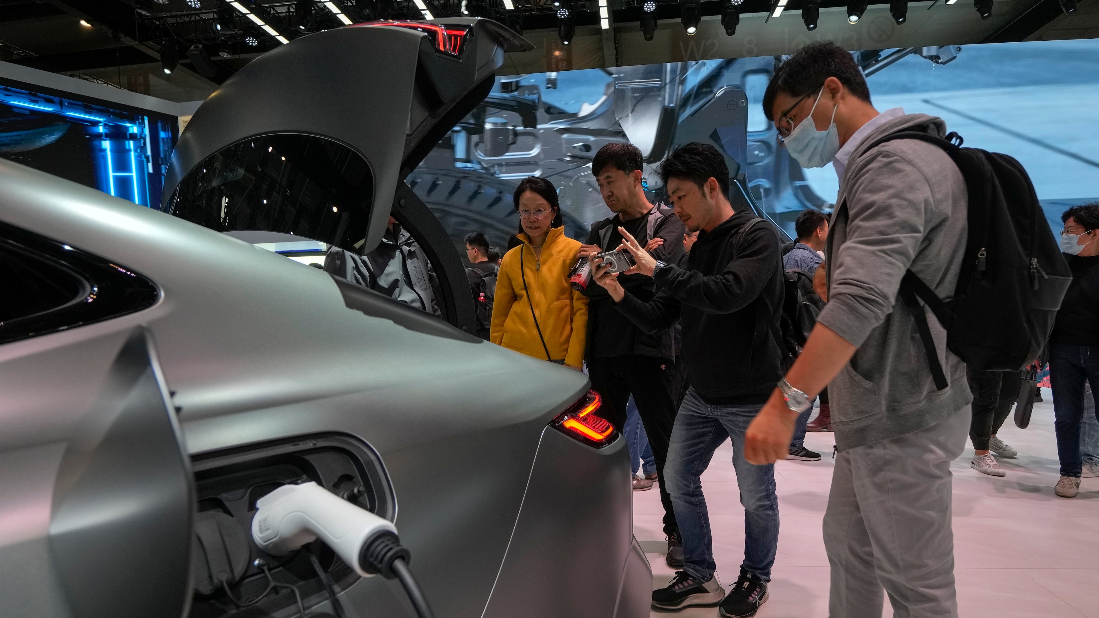FILE - Visitors look at a Geely Galaxy E8 electric car during the Auto China 2024 in Beijing, Sunday, April 28, 2024. (AP Photo/Andy Wong, File)
