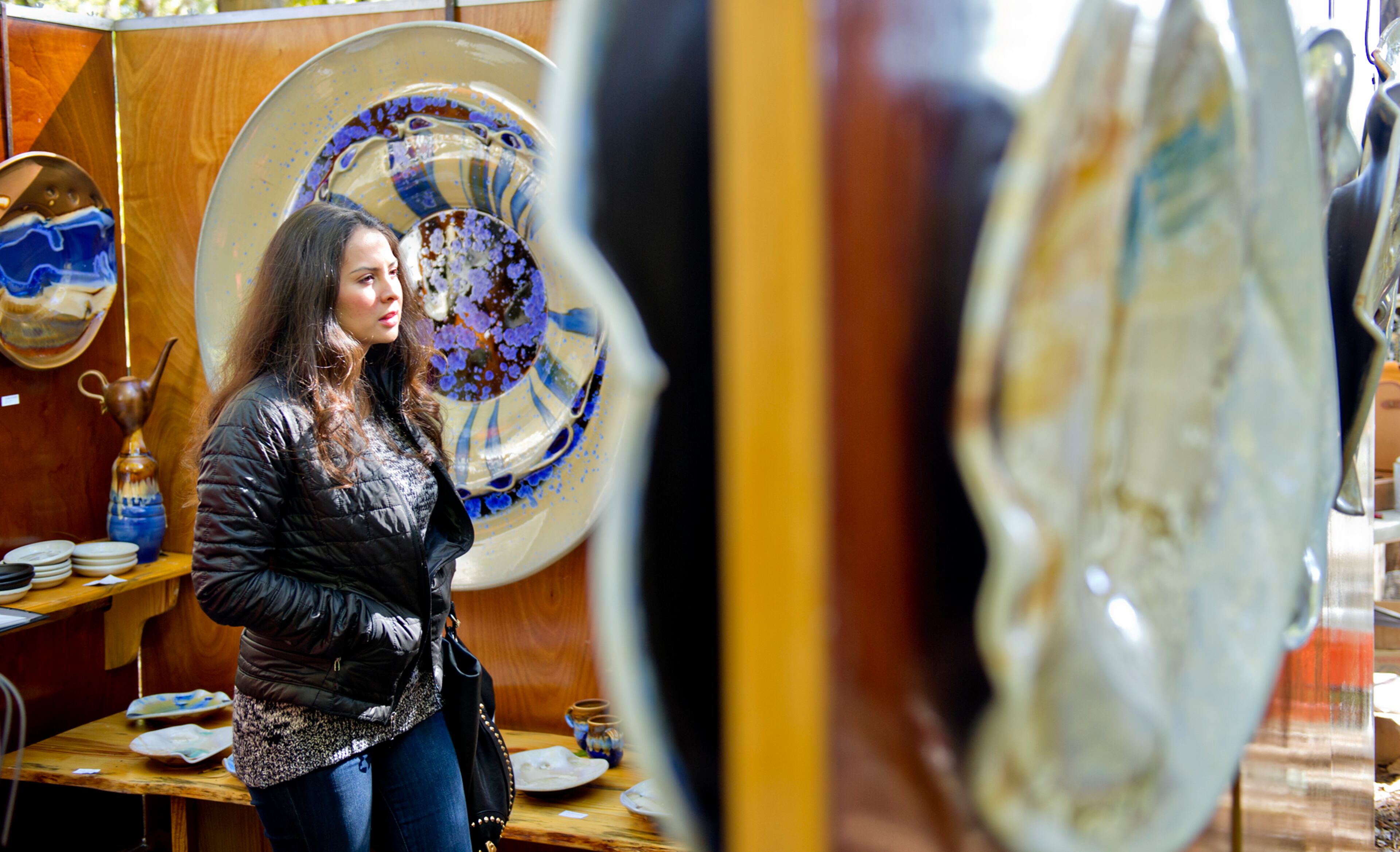 Margaret Bierman walks through Craig McMillin's booth during the Chastain Park Art Festival in Atlanta on Sunday, November 2, 2014. Although cold temperatures kept attendance down on Saturday, the sun on Sunday brought out thousands of people to check out art by local, regional and national artists. JONATHAN PHILLIPS / SPECIAL
