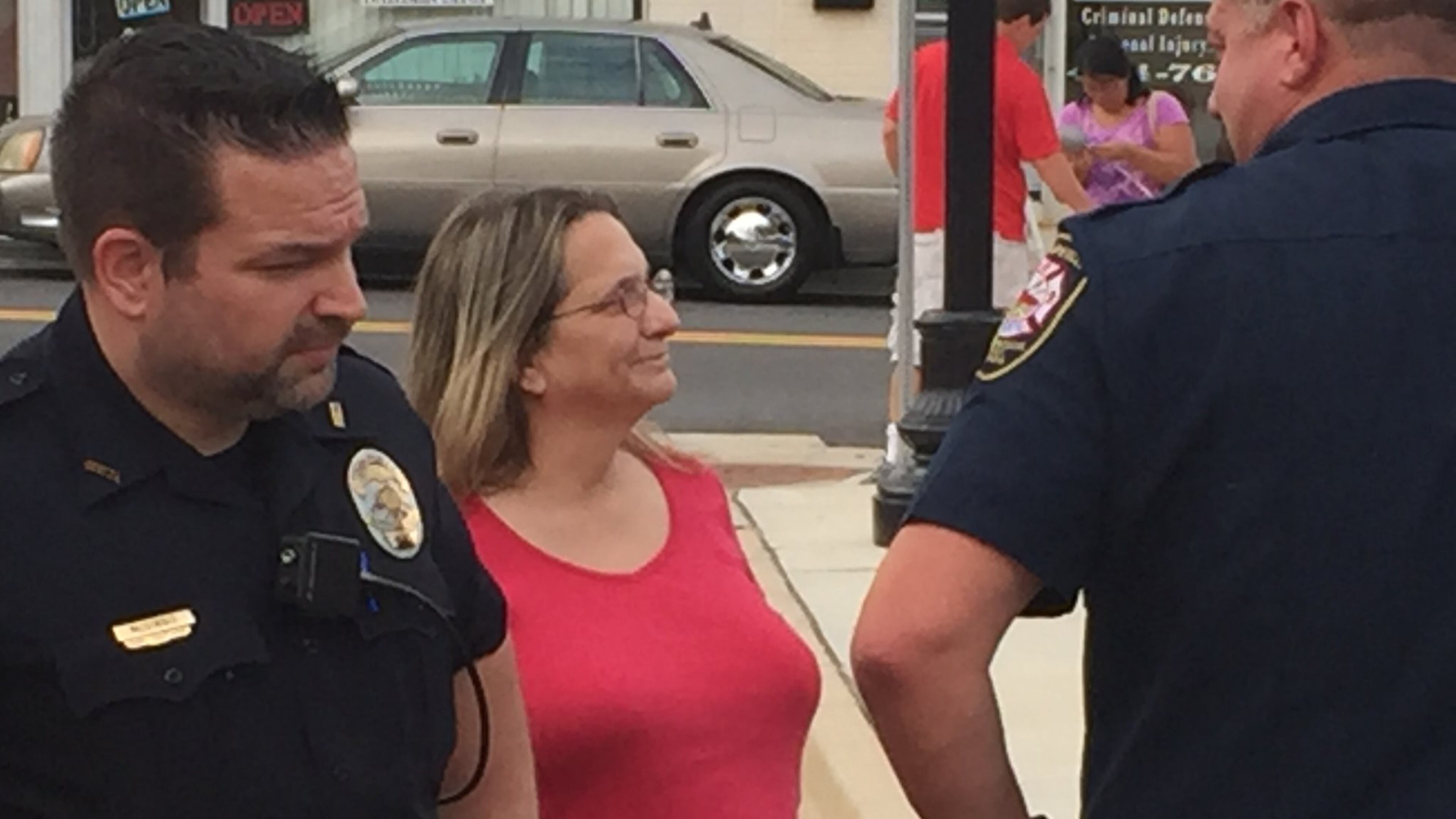 Hapeville City Councilwoman Ruth Barr talks with officers on Aug. 4, 2016, outside City Hall at the city s night out on crime event. Detective Justin McGinnis, left, signed a July 6 arrest warrant for Barr that officers later failed to execute. The department s handling of the warrant is now under review.