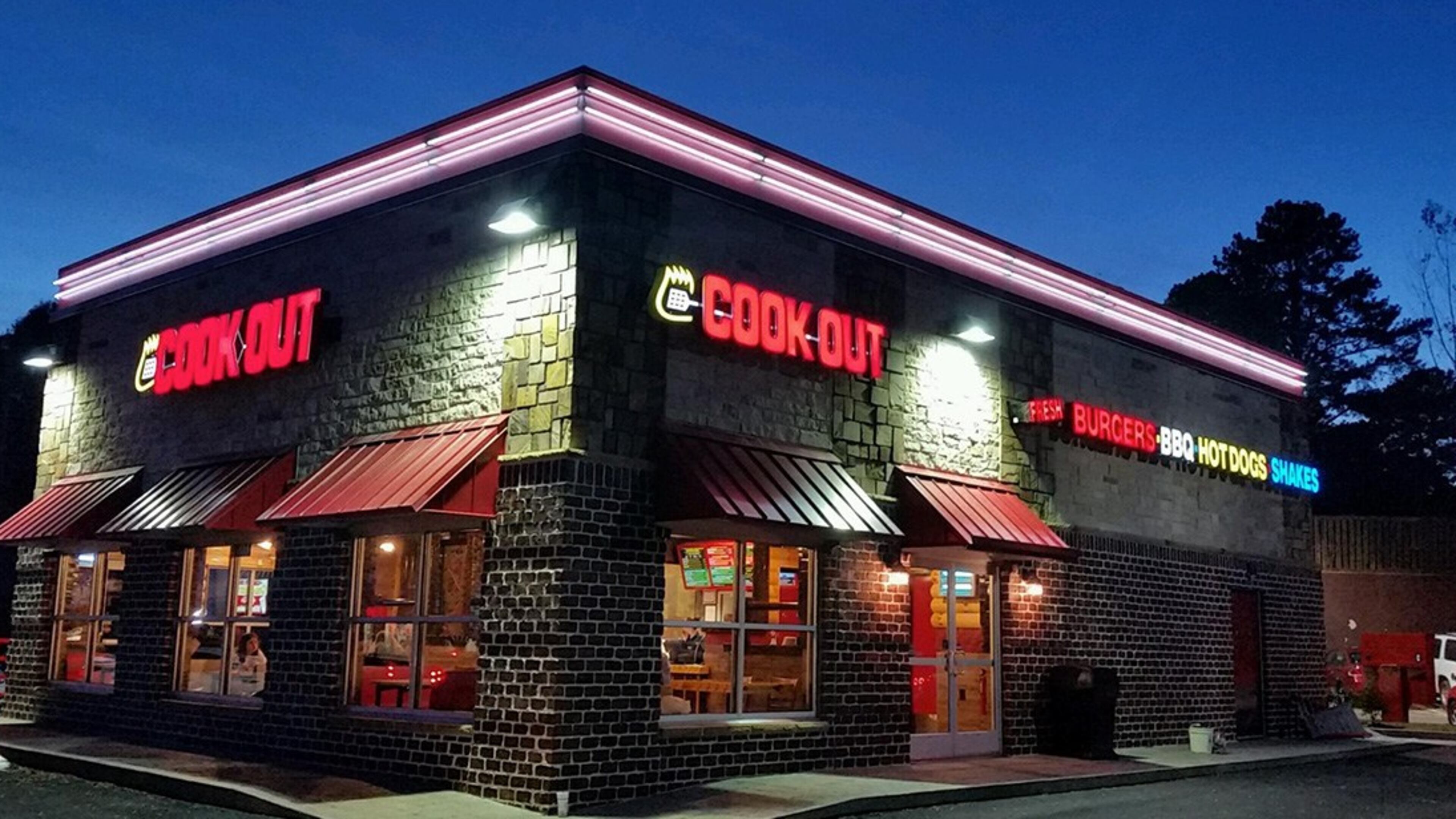 Two men were injured at a Cook Out in Lithonia after they argued with a man who shot each of them in the leg, police said. Both men are expected to recover and DeKalb police continue to search for the suspect.