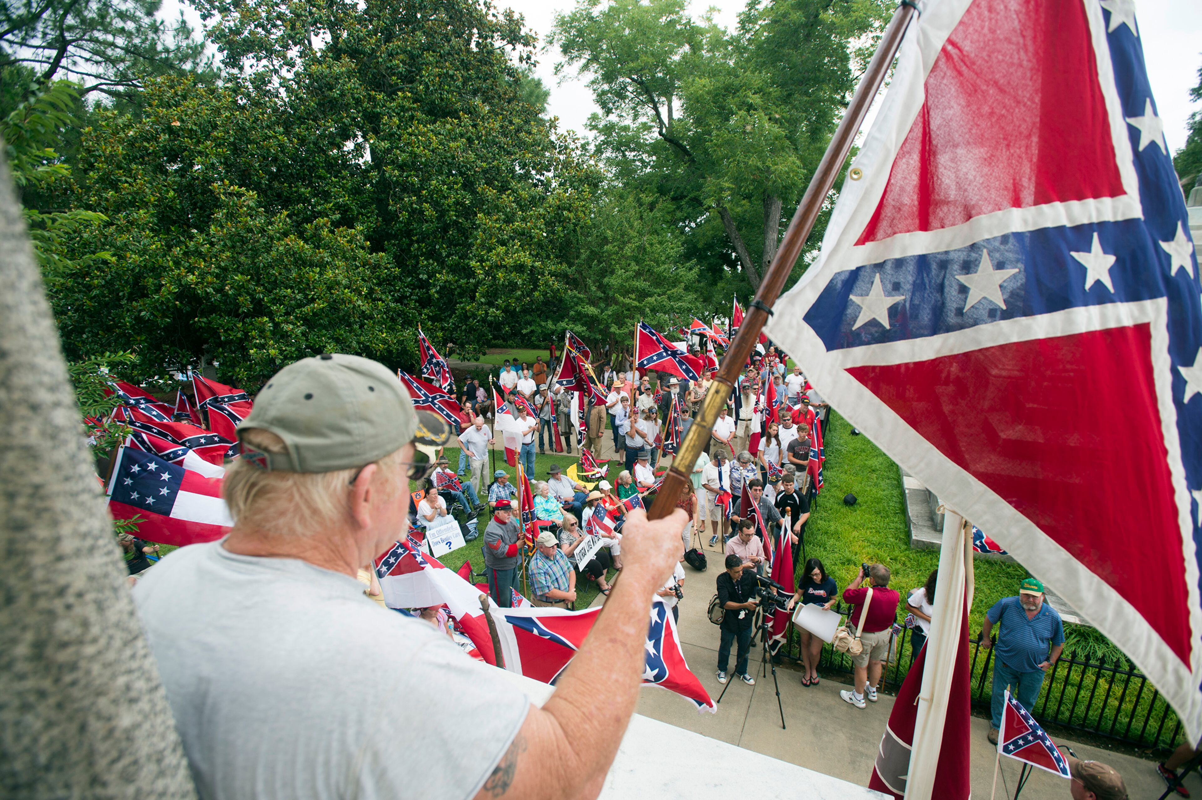 Wayne Morrison holds a Confederate flag at Alabama State Capitol building during a Confederate flag rally on Saturday, June 27, 2015, in Montgomery, Ala. (Albert Cesare/The Montgomery Advertiser via AP) NO SALES; MANDATORY CREDIT