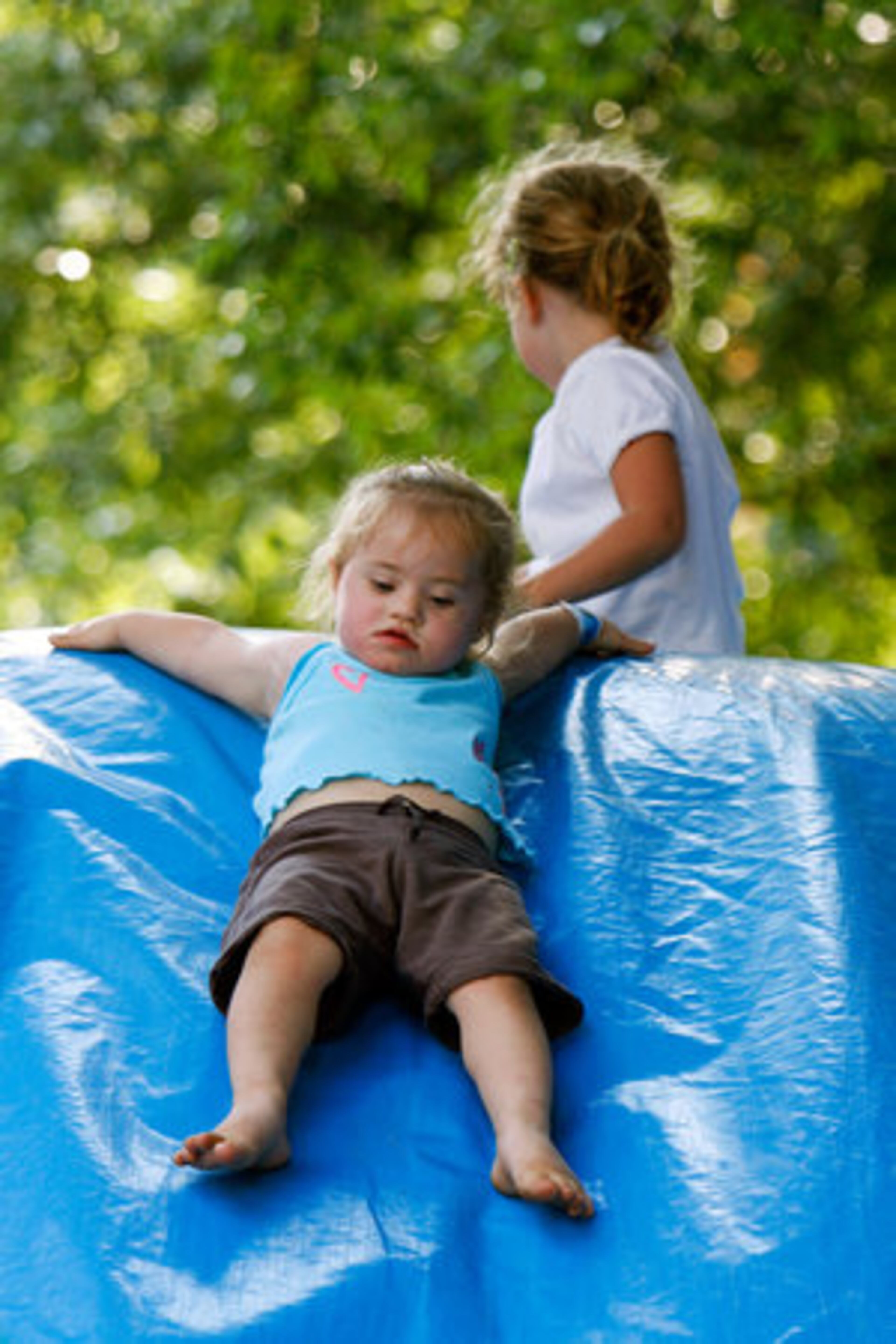 Katie O'Keefe, 2, cautiously lets herself down a moonwalk slide at the Decatur Beach Party.