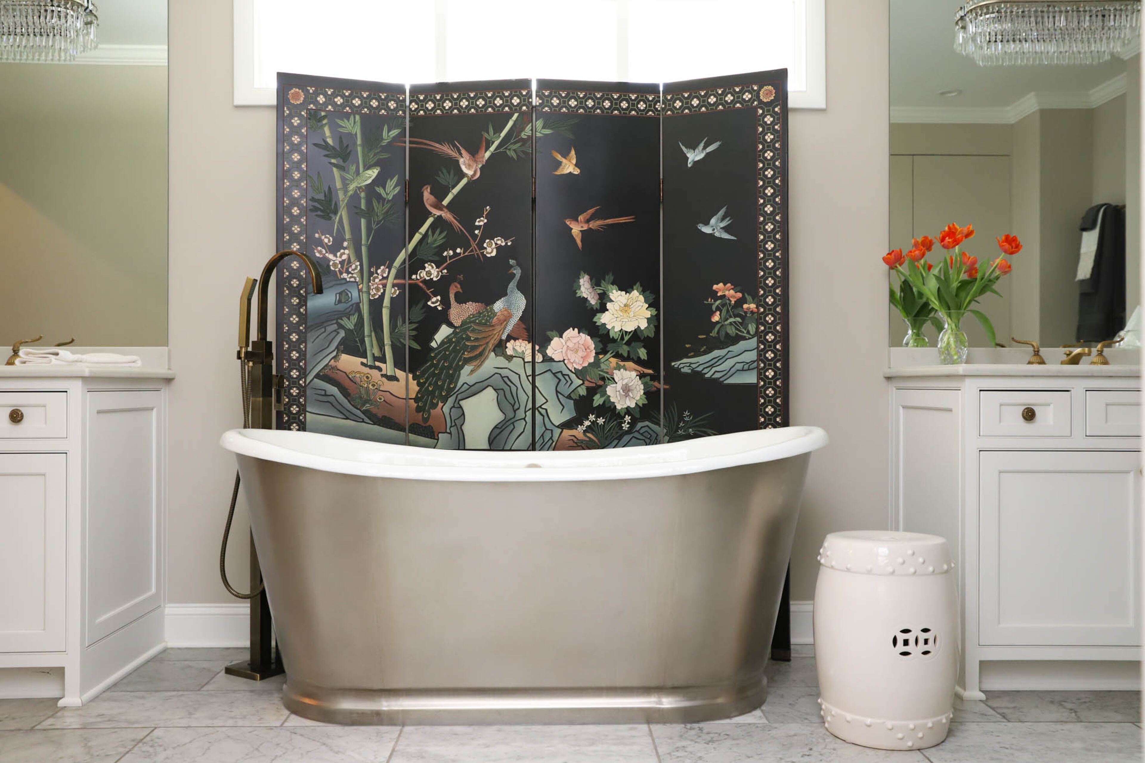 John and Jane Hall worked with Josiah’s Remodeling & Repair Inc. to renovate their owner’s suite, restructuring their bathroom and creating new master closets. The renovation included new Carrara marble floors and tile from Floor & Decor and a new stainless steel wrapped pedestal tub from Signature Hardware. Jane found the screen behind the tub in a consignment shop in Chamblee, and decided the pairs of love birds it depicted were perfect for the couple’s bathroom. Text by Shannon Dominy/Photo by Reynolds Rogers