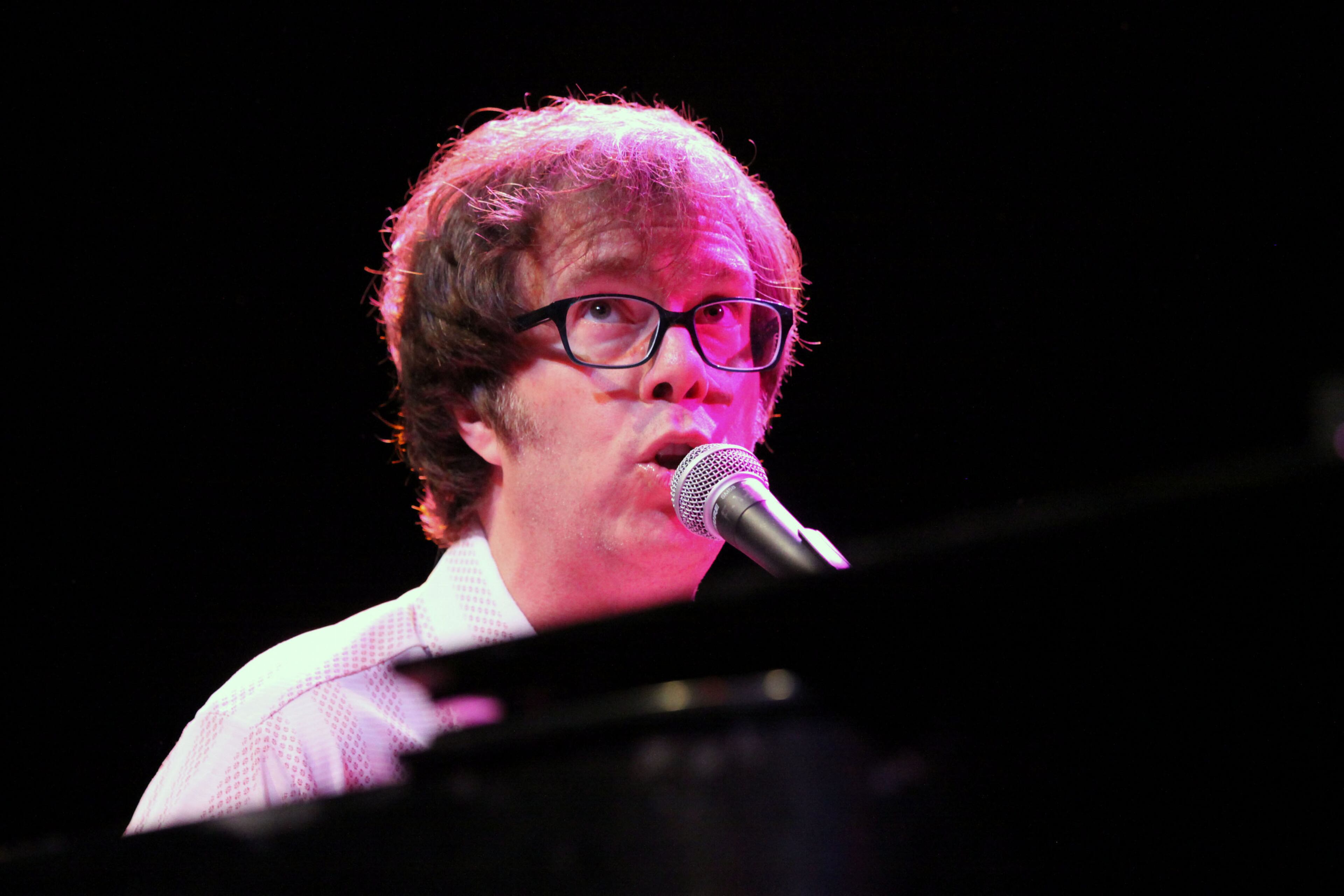 Folds bangs out a tune on his piano.