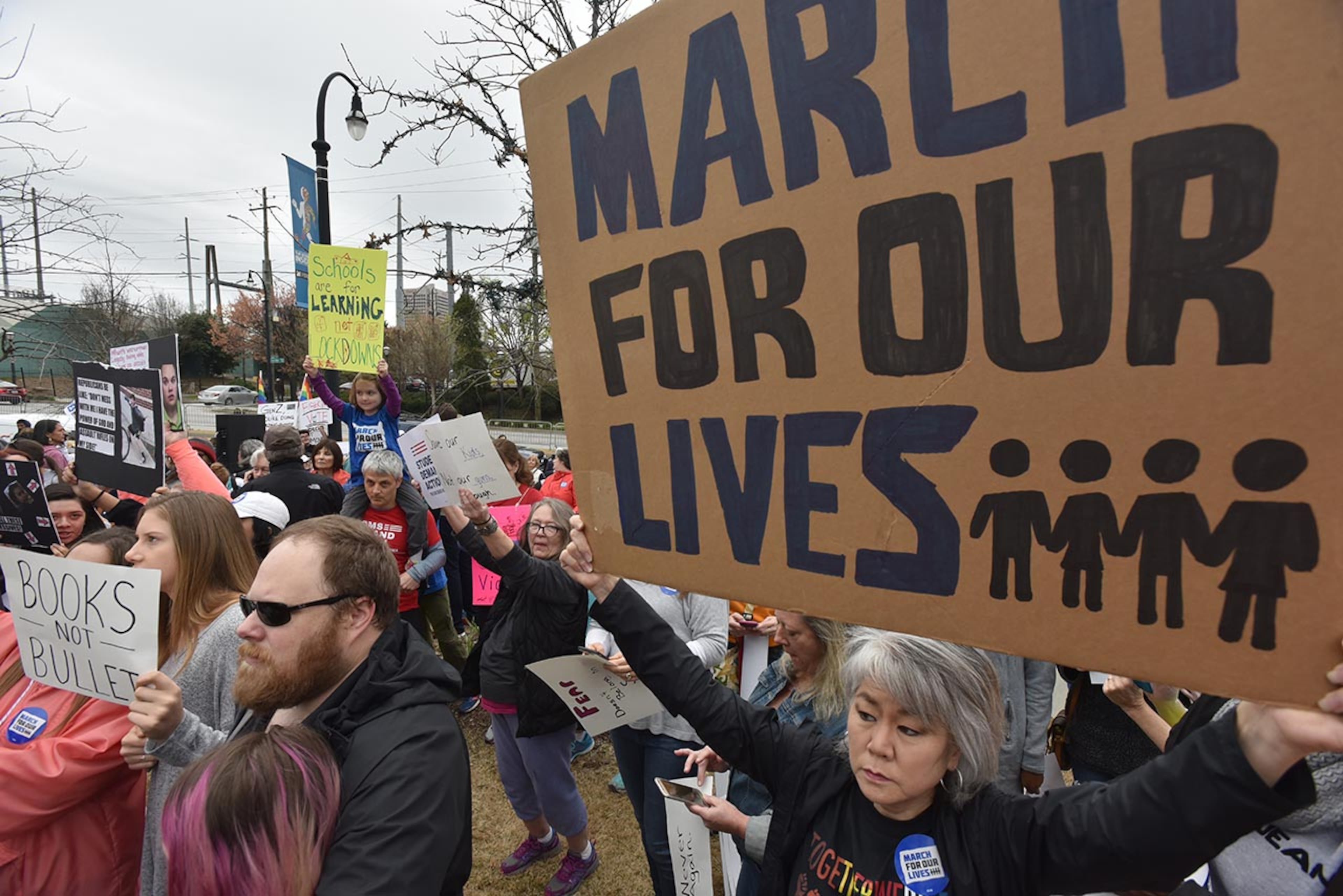 March 24, 2018 Atlanta - People hold signs as they participate in the March For Our Lives rally at the Center for Civil and Human Rights before walking to Liberty Plaza on Saturday, March 24, 2018. Atlanta police estimated the crowd at near 30,000 for todayâÃôs March for Our Lives. People of all ages were drawn to one of the nationwide demonstrations in a movement begun by student survivors of last monthâÃôs mass killing in a Parkland, Fla., school. Some of those Florida students were among the speakers in Atlanta. HYOSUB SHIN / HSHIN@AJC.COM