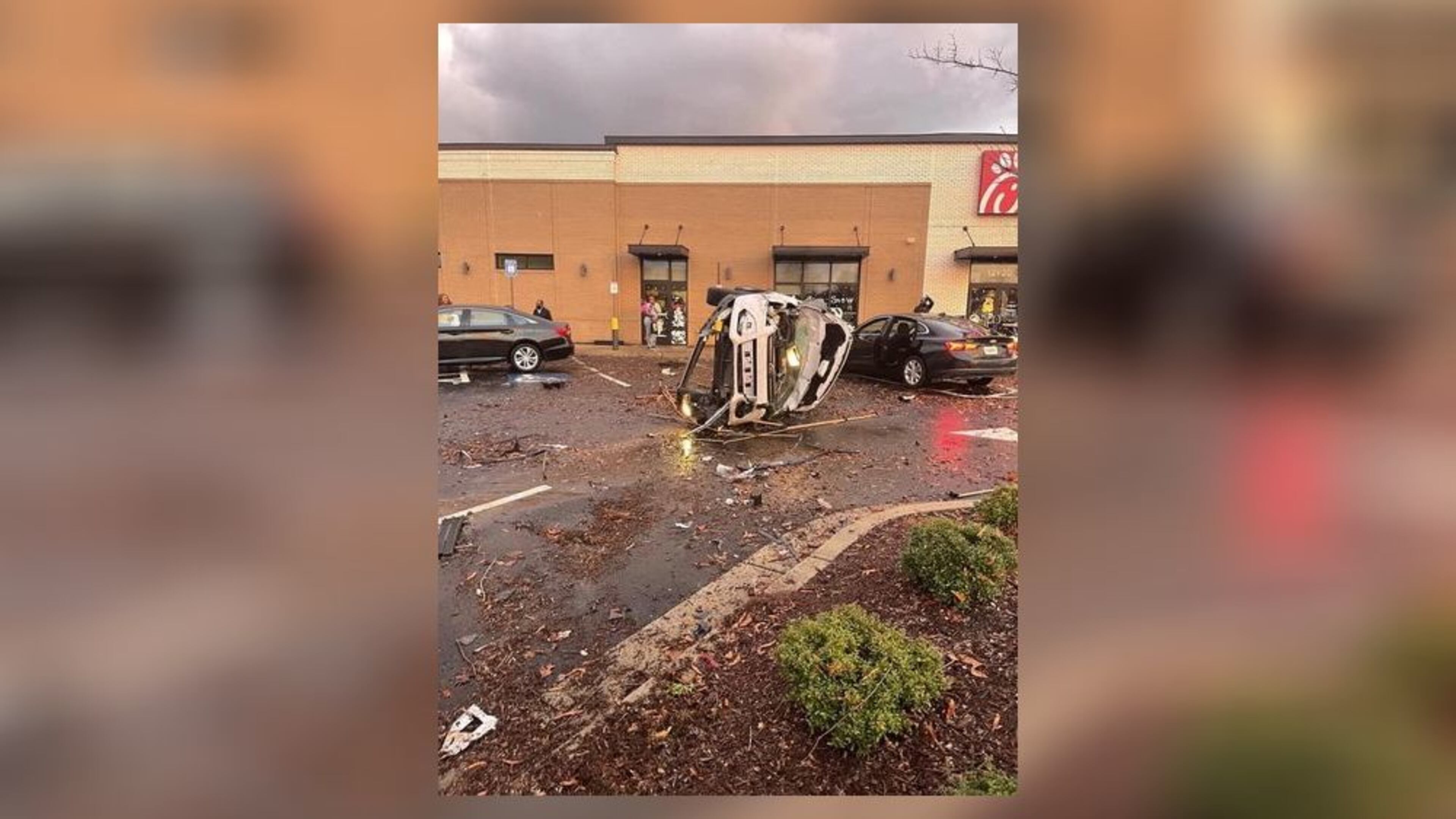 Powerful winds from a tornado overturned and damaged vehicles parked outside a Chick-fil-A in Newton County on Friday, the National Weather Service confirmed. (Credit: Channel 2 Action News)
