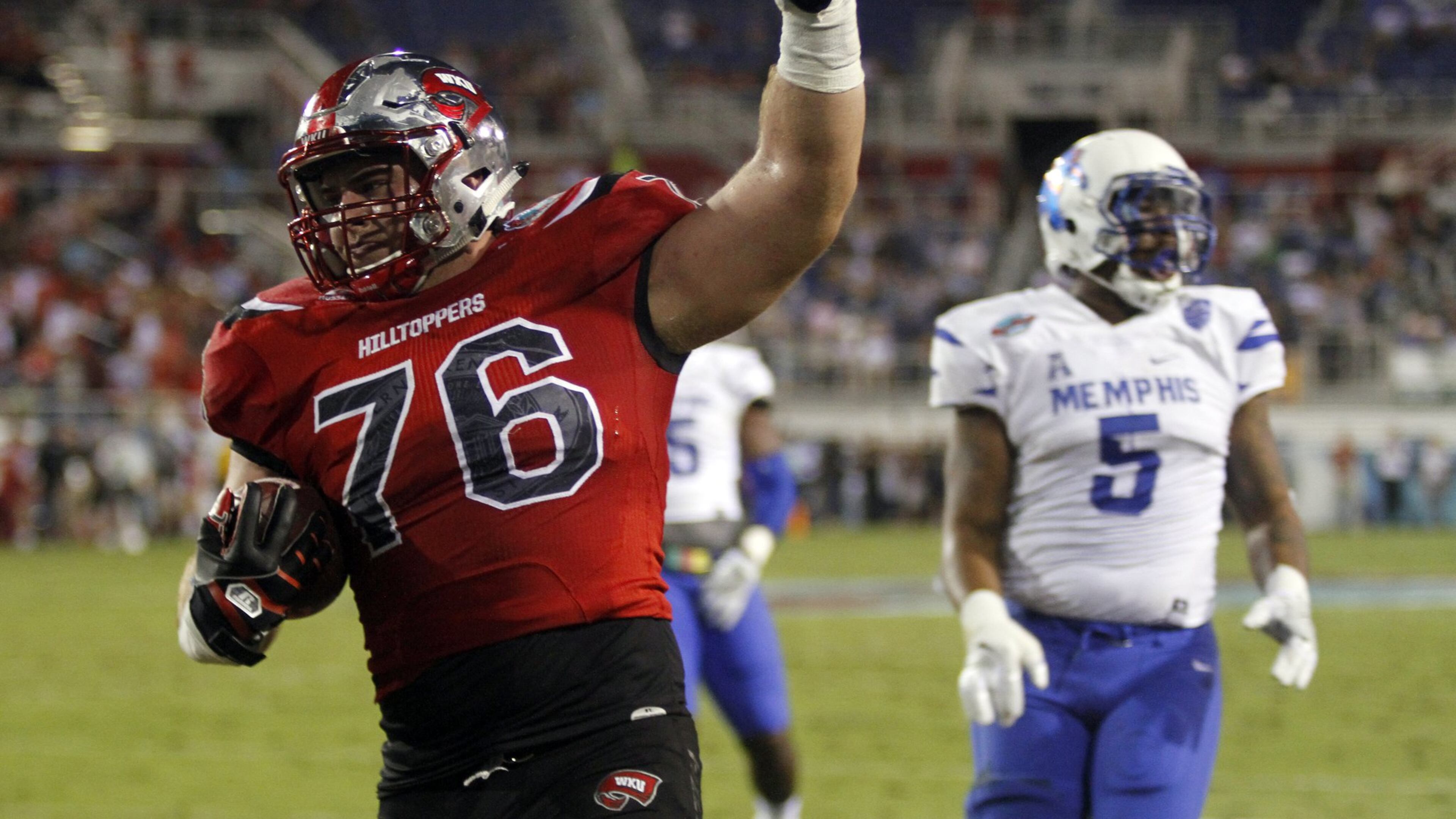 FILE - This Dec. 20, 2016, file photo shows Western Kentucky offensive lineman Forrest Lamp scoring a touchdown against Memphis during the Boca Raton Bowl NCAA college football game in Boca Raton, Fla. NFL scouts love Lamp, but his frame and arm length suggest more guard than tackle. If he was a sure-thing tackle he would probably be a top-10 pick. Instead, middle of the first.(Adam Sacasa/South Florida Sun-Sentinel via AP)