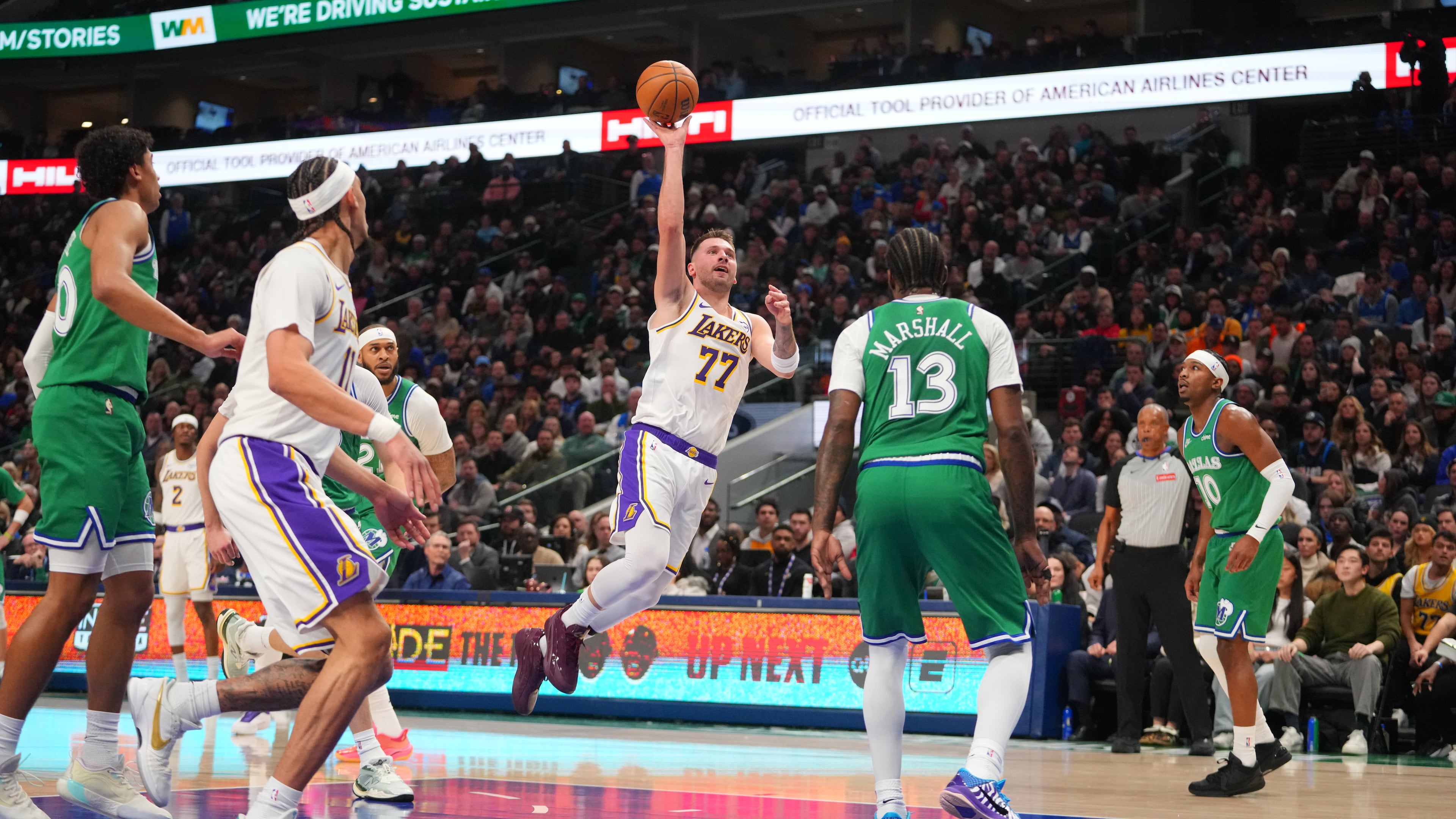 Los Angeles Lakers guard Luka Doncic (77) throws up a shot against Dallas Mavericks forward Naji Marshall (13) during the first half of an NBA basketball game Saturday, Jan. 24, 2026, in Dallas. (AP Photo/Julio Cortez)
