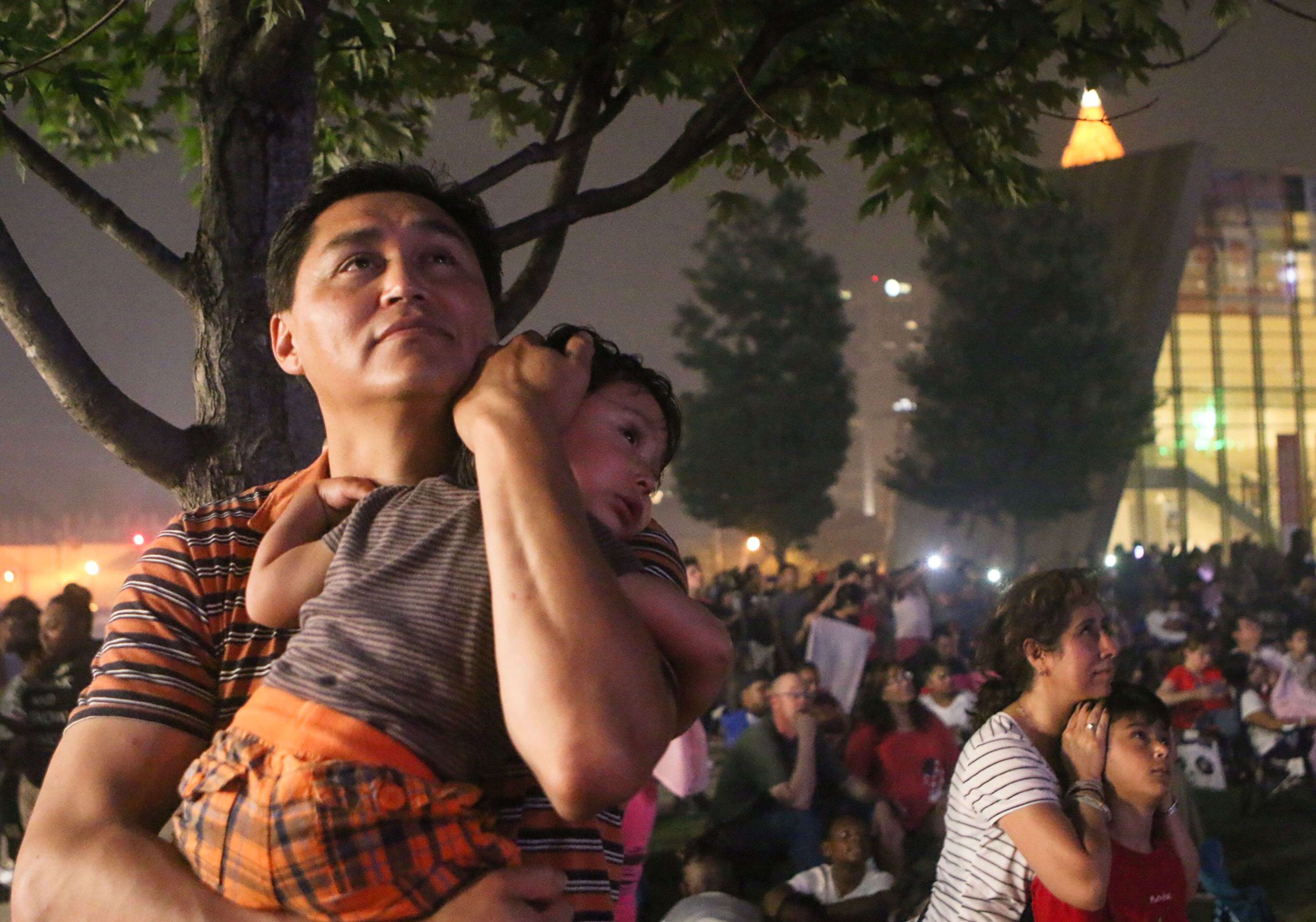 A man embraces his son while they watch fireworks at Centennial Olympic Park in Atlanta. Christina Matacotta/Christina.Matacotta@ajc.com