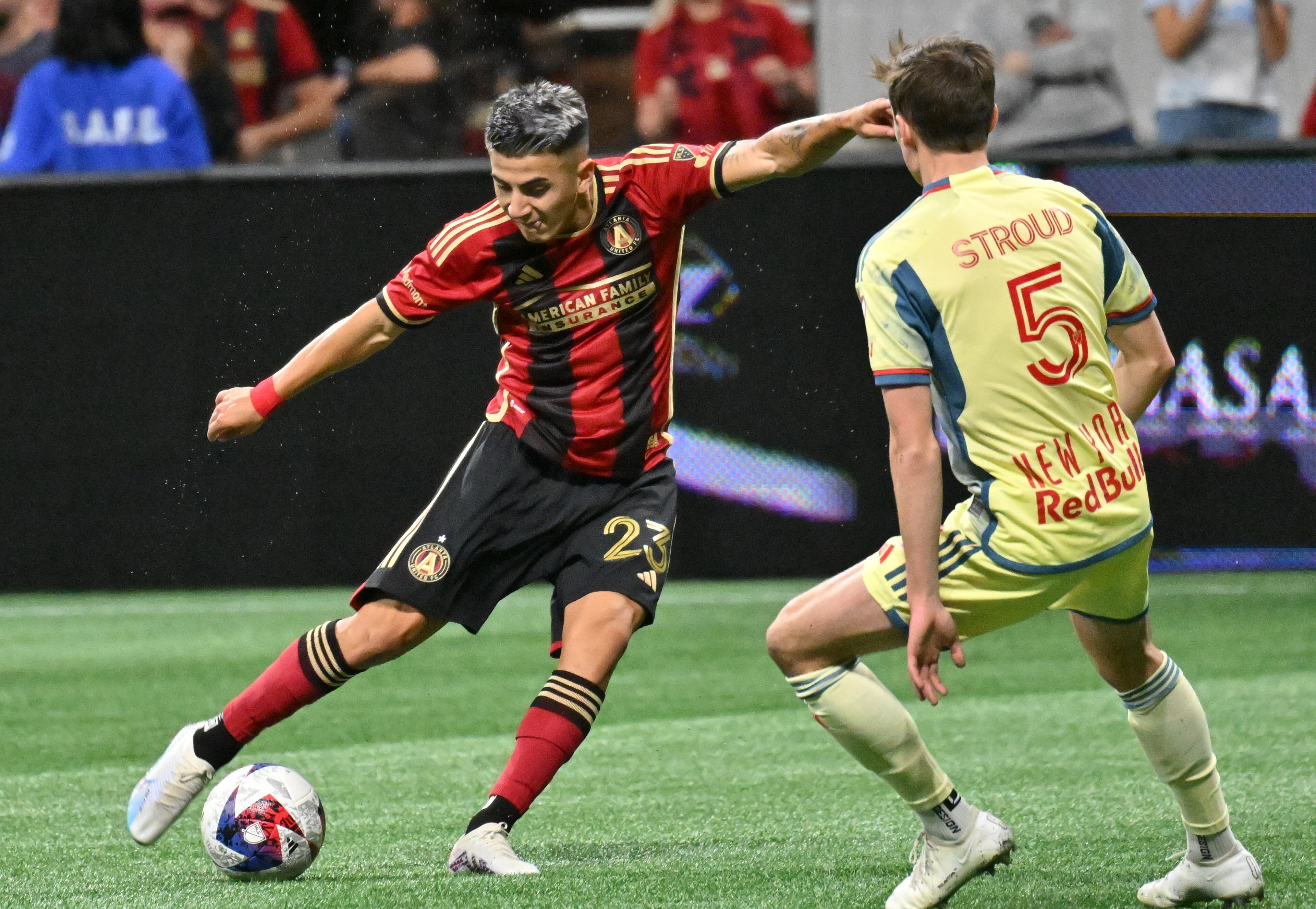 Atlanta United's midfielder Thiago Almada (23) shoots against New York Red Bulls' midfielder Peter Stroud. (Hyosub Shin / Hyosub.Shin@ajc.com)