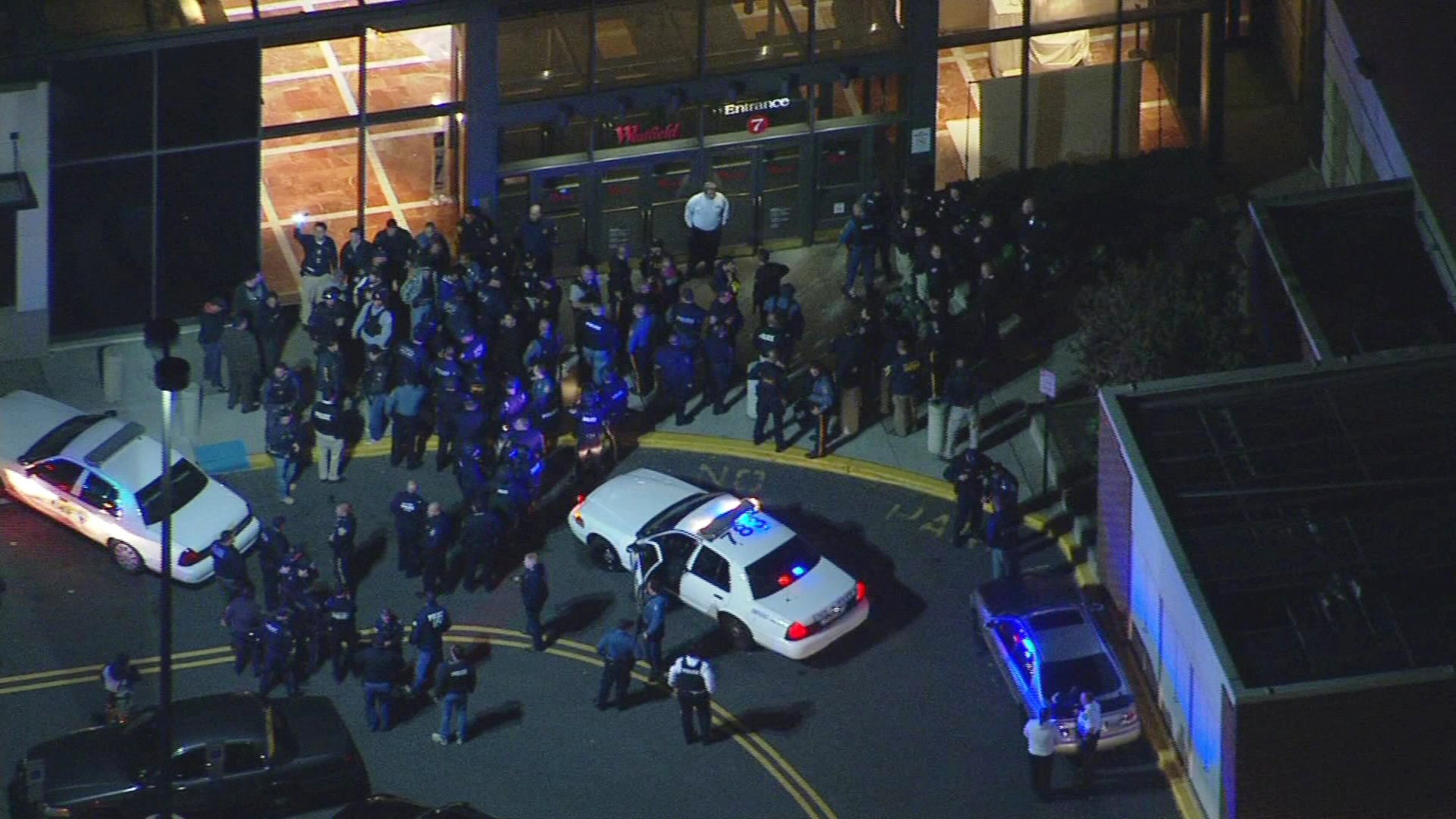 In this image provided by News 12 New Jersey, authorities converge on the Garden State Plaza Mall, late Monday, Nov. 4, 2013, in Paramus, N.J., after there were reports of multiple shots being fired inside the mall. (AP Photo/News 12 New Jersey)