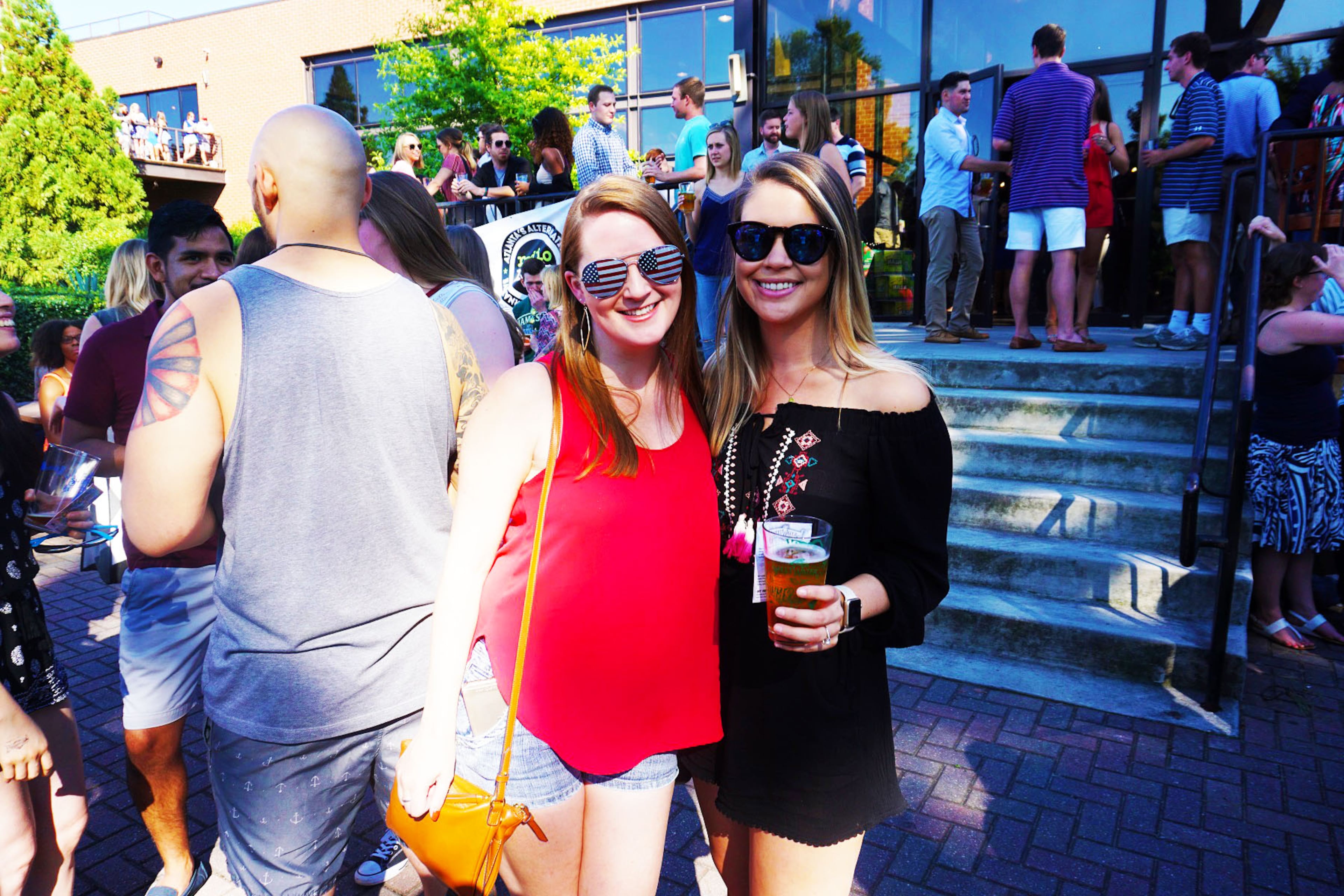 Catherine Akin and Brooke McHale pose for a photo during SweetWater's I Survived I-85 party.