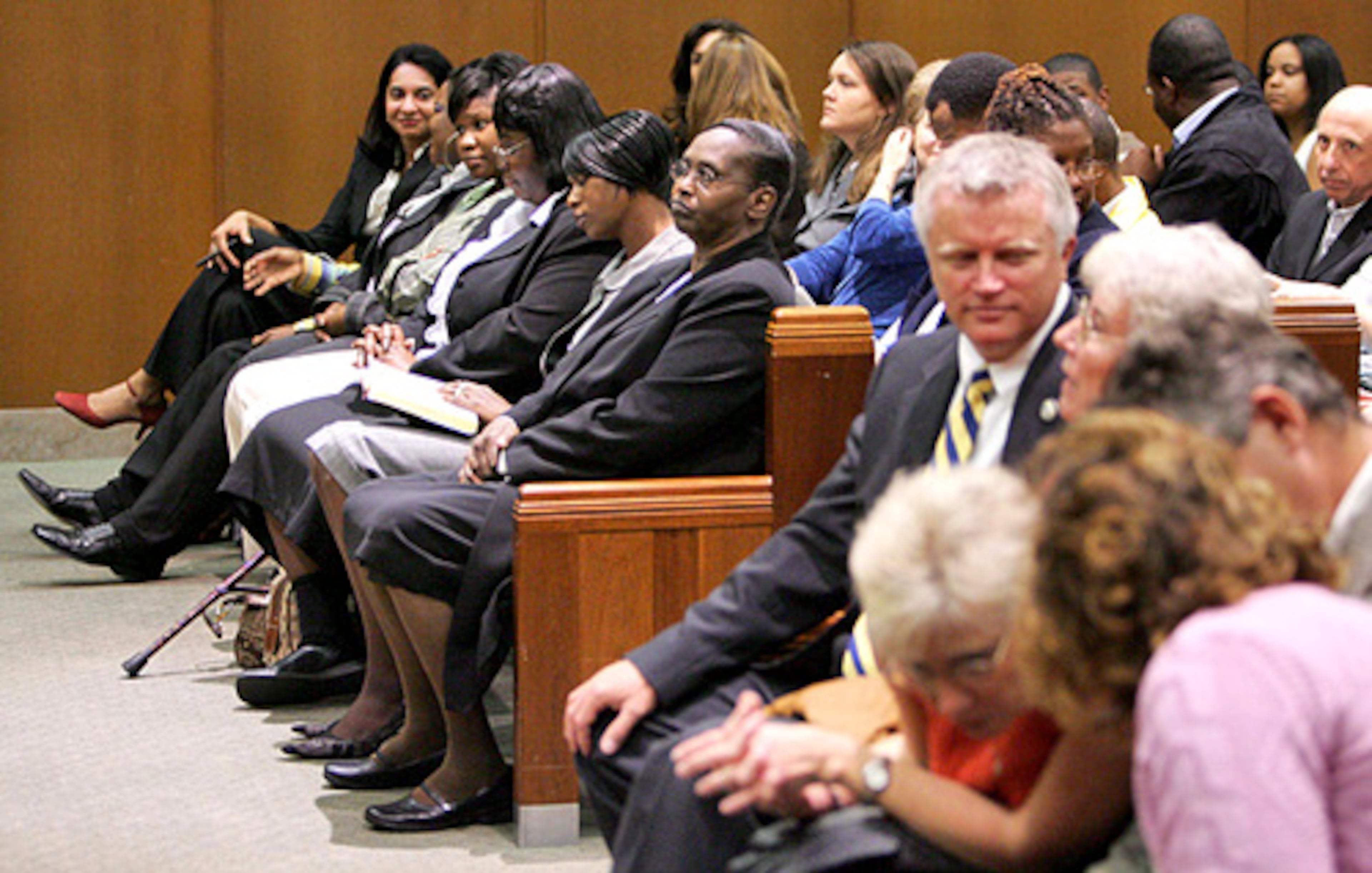 Members of the Davis family sit on one side of the front row (left) and members of the MacPhail family sit on the other side.