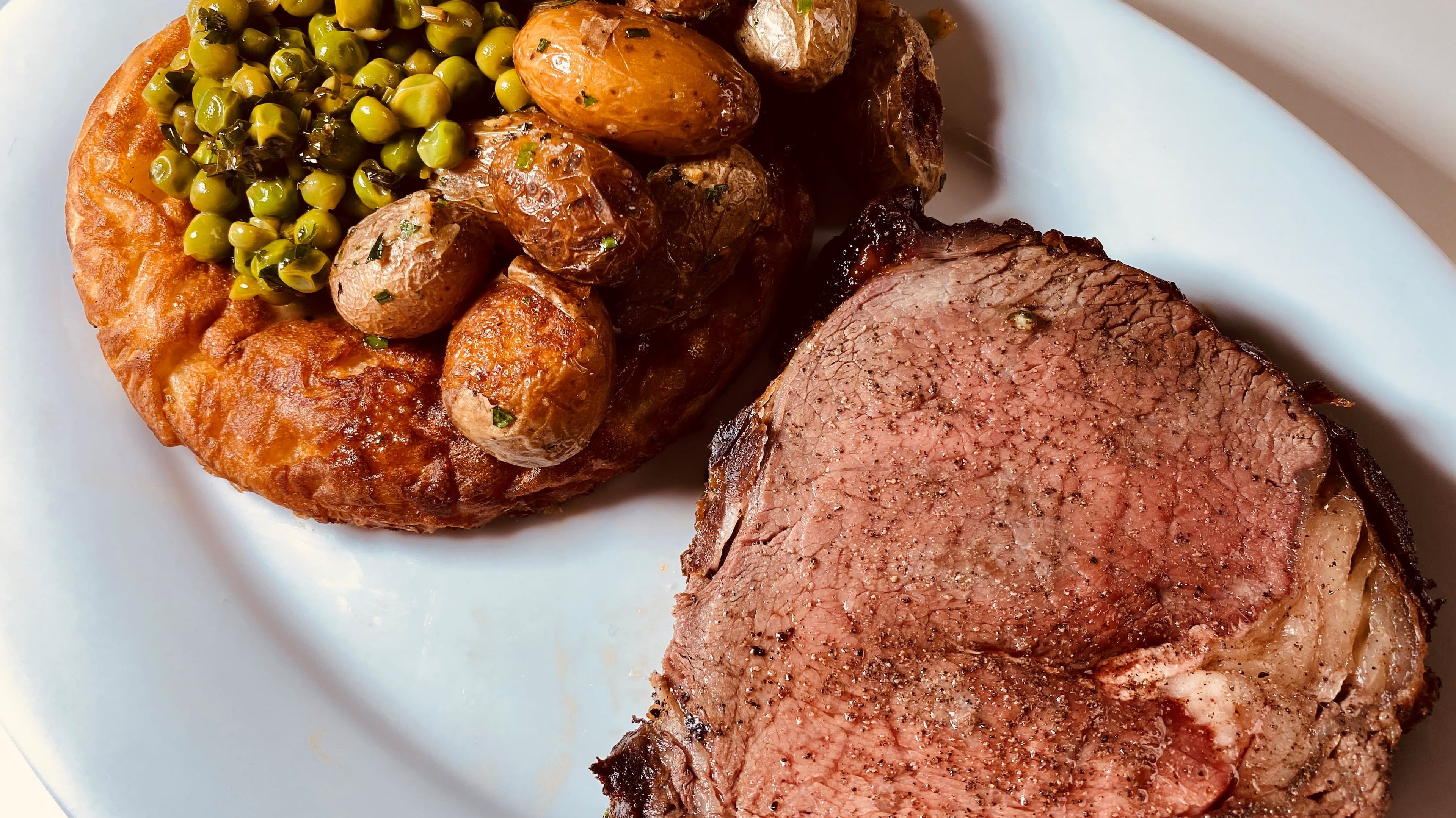 King + Duke's Sunday roast includes prime rib, roasted potatoes, spring peas with mint and steel pudding. Bob Townsend for The AJC