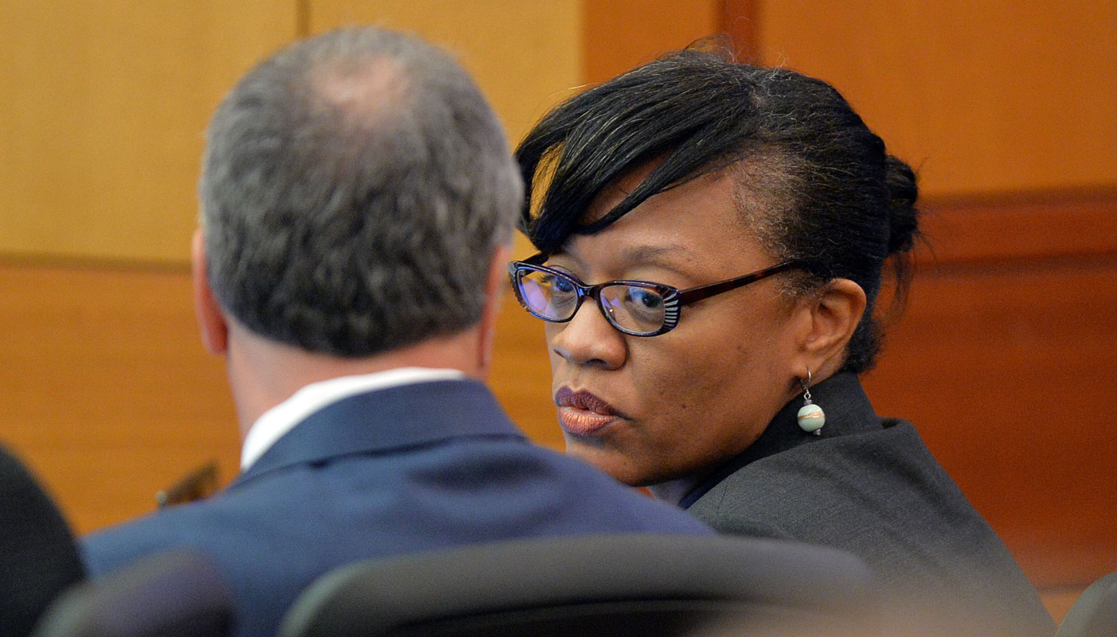 Defendant Dana Evans talks to her attorney, Robert Rubin, during the prosecution's opening statement Monday. The prosecution lays out its case during an expected three-hour-long opening statement to kick off the Atlanta Public Schools test-cheating trial before Judge Jerry Baxter in Fulton County Superior Court, Monday September 29, 2014. Not all 12 defense lawyers will be making opening statements; some are planning to reserve theirs until after the prosecution presents its case. KENT D. JOHNSON / KDJOHNSON@AJC.COM