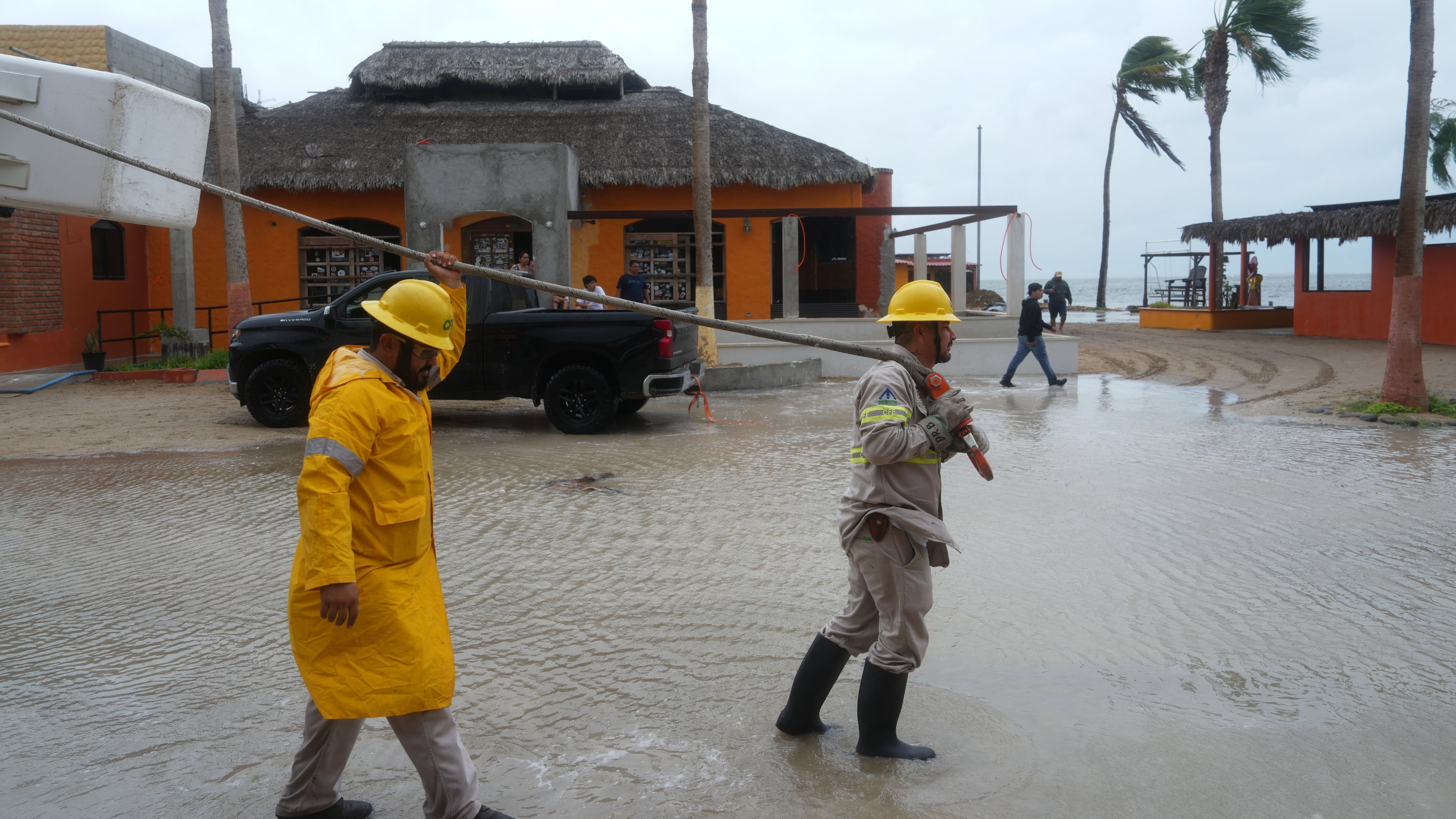 Workers pull a boat to shore as Hurricane Polo approaches Puerto San Carlos, Baja California Sur state, Mexico, Monday, Sept. 28, 2026. (AP Photo/Eduardo Verdugo)