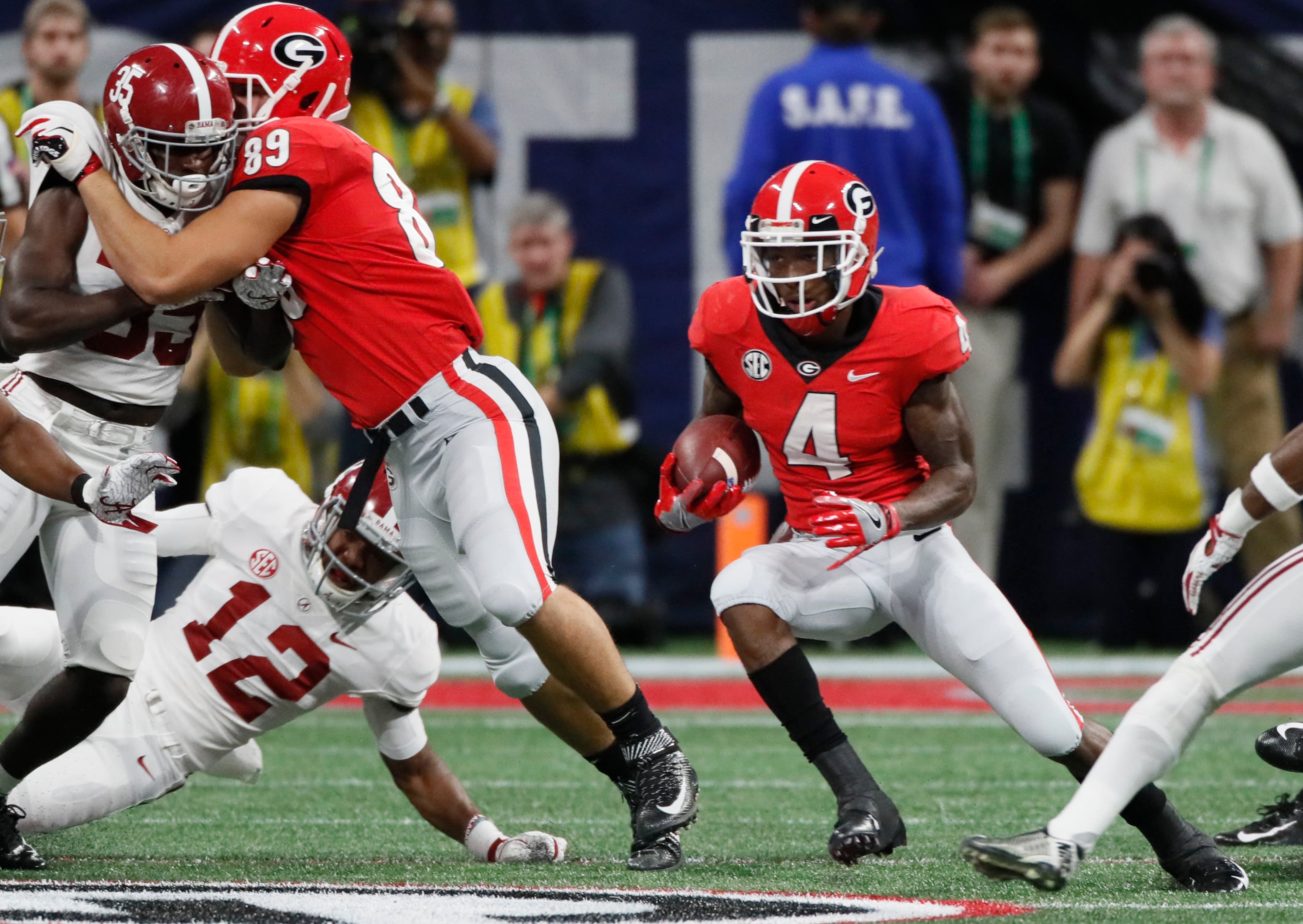 12/1/18 - Atlanta - Georgia Bulldogs wide receiver Mecole Hardman (4) returns an Alabama kickoff to 26 during the first half. The University of Georgia Bulldogs played the Alabama Crimson Tide in a NCAA college football game for the Southeastern Conference Championship Saturday, Dec. 1, 2018, at Mercedes-Benz Stadium in Atlanta, GA. BOB ANDRES / BANDRES@AJC.COM