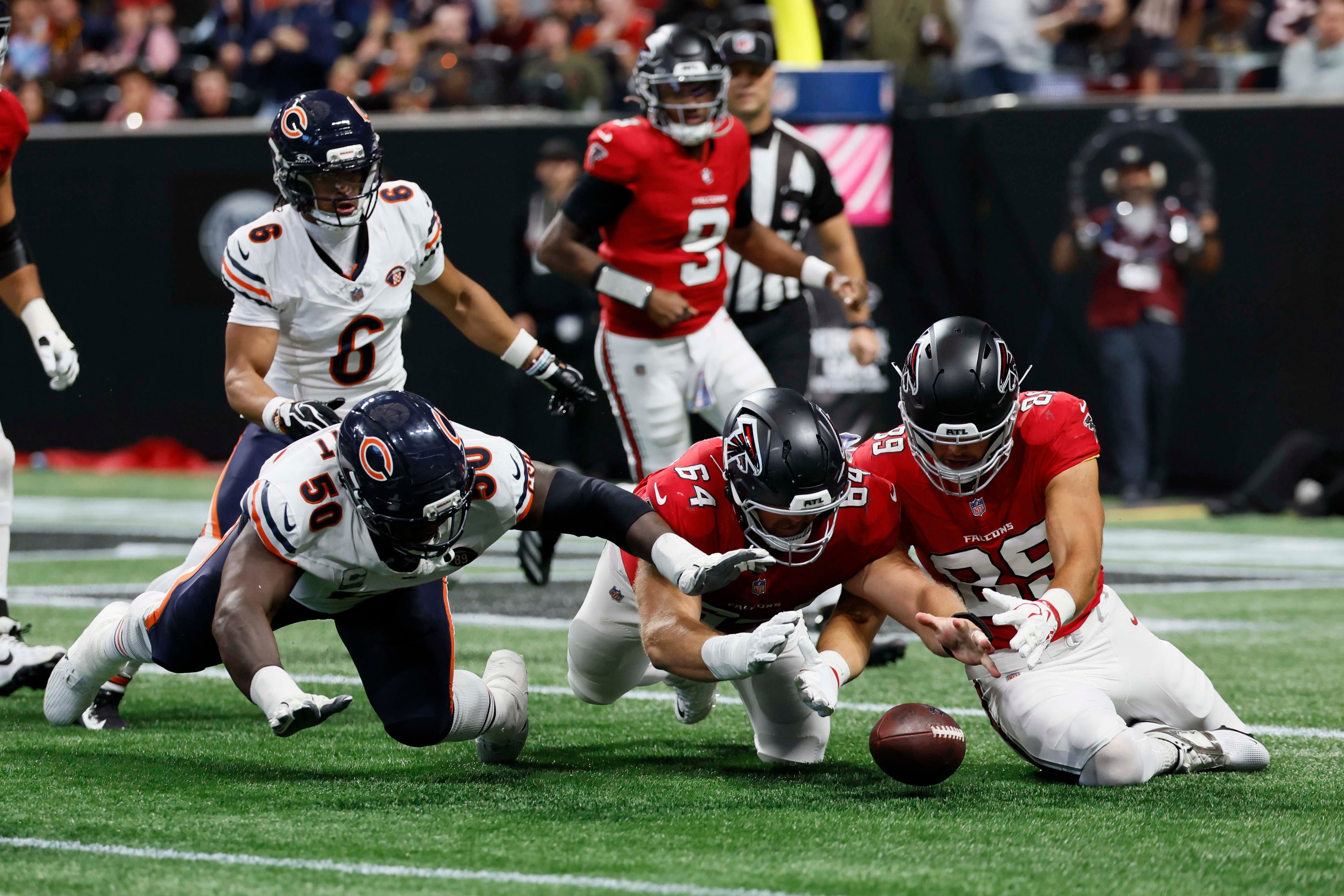 Atlanta Falcons defensive end Brandon Dorlus (center) tries to recover a fumble from Atlanta Falcons quarterback Michael Penix Jr. during the second half of an NFL football game against the Chicago Bears at Mercedes-Benz Stadium in Atlanta on Sunday, Oct. 18, 2026. (Miguel Martinez/AJC)