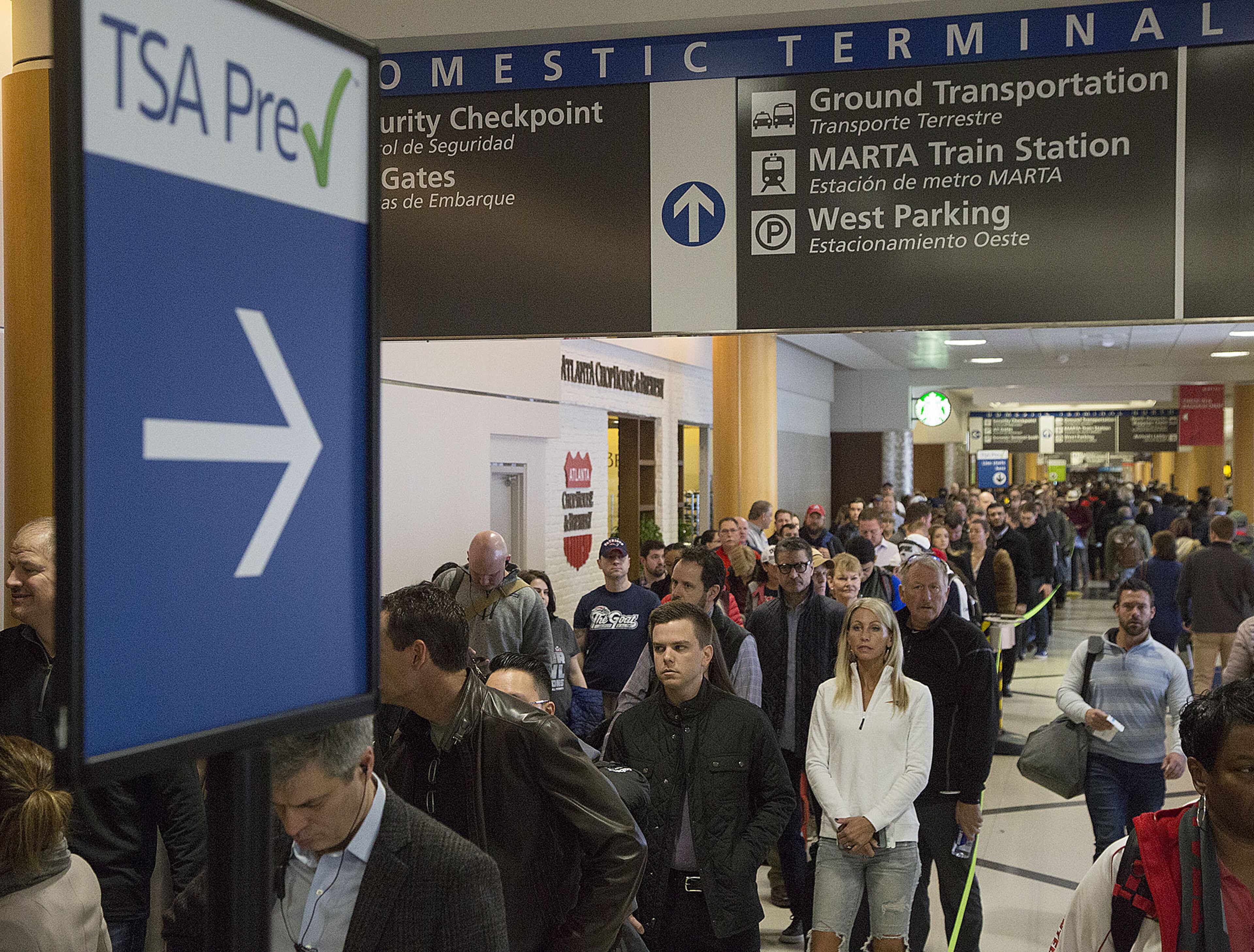 Multiple security lines at Hartsfield-Jackson International Airport ran across the atrium then snaked through baggage claim in both domestic terminals on Monday February 4th, 2019. Official expected over 100,00 travelers to pass through the airport today. (Photo by Phil Skinner)