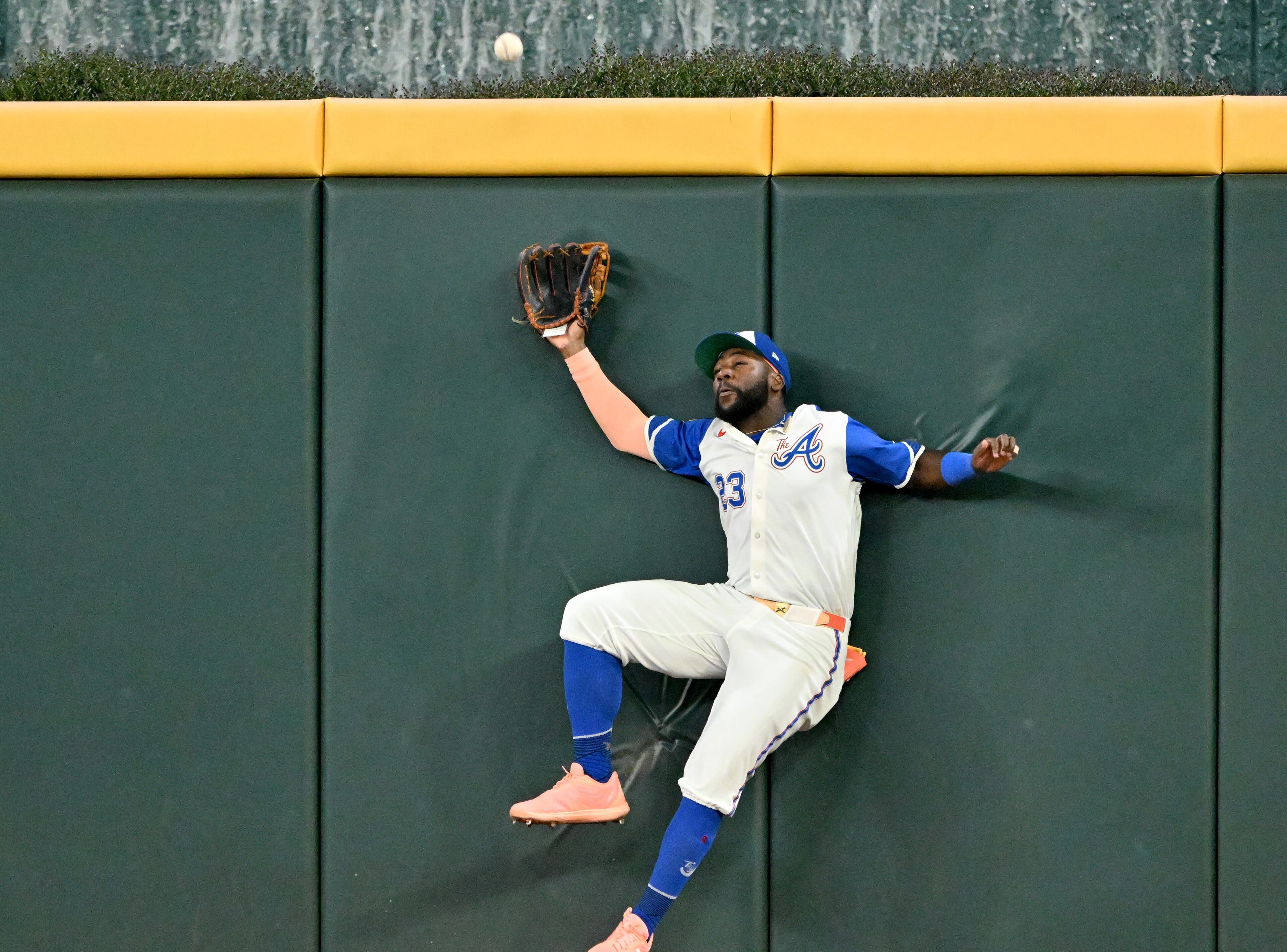 Atlanta Braves outfielder Michael Harris II (23) hits the wall as he fails to catch a double by New York Yankees first base Paul Goldschmidt (48) during the ninth inning of a baseball game at Truist Park, Saturday, July 19, 2025, in Atlanta. New York Yankees won 12-9 over Atlanta Braves. (Hyosub Shin / AJC)