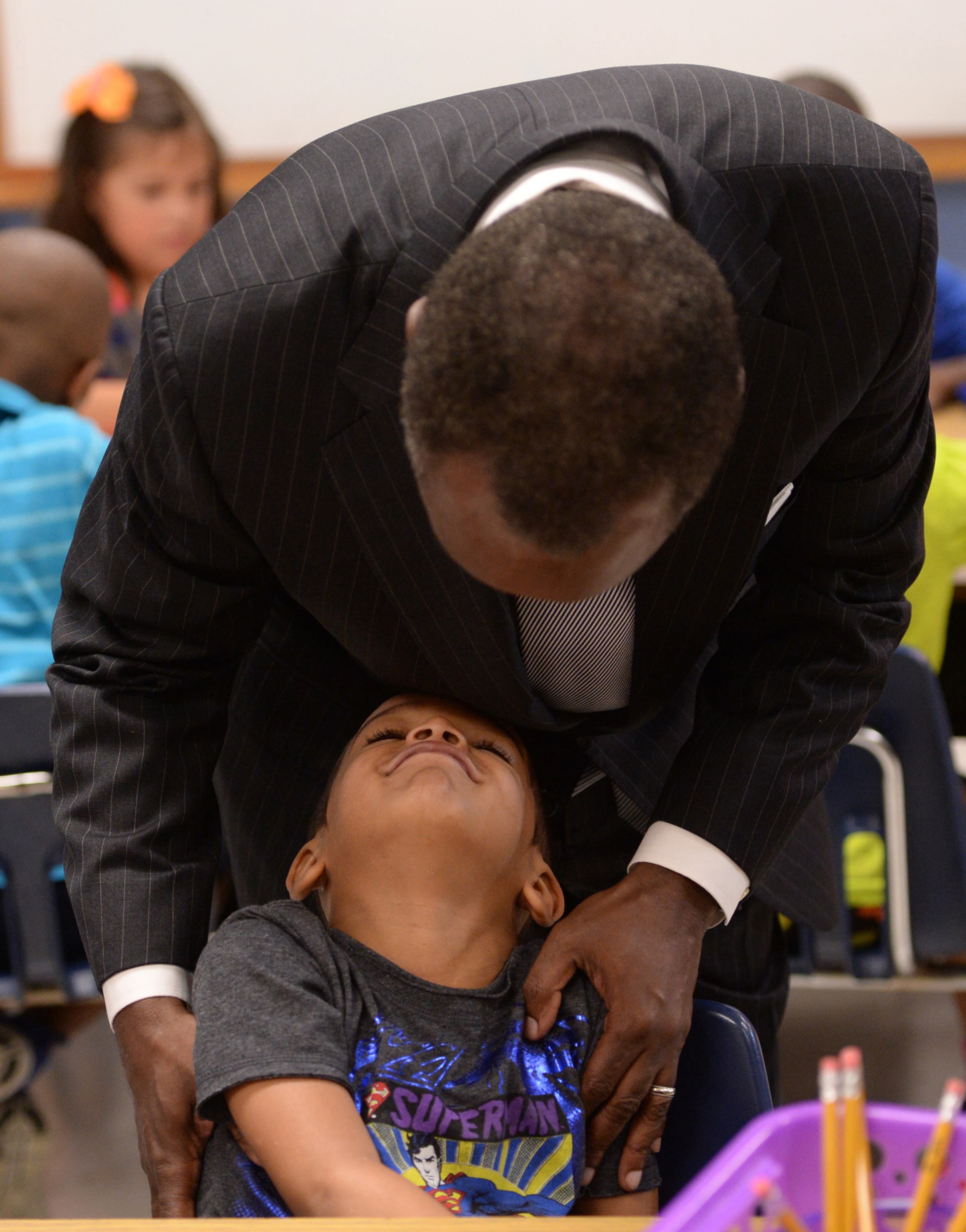 Javan Carter smiles as he looks up at DeKalb County School District Superintendent Michael Thurmond on the first day of school at Midvale Elementary on Monday, August 12, 2013. Thurmond was touring the school on the first day. JOHNNY CRAWFORD / JCRAWFORD@AJC.COM