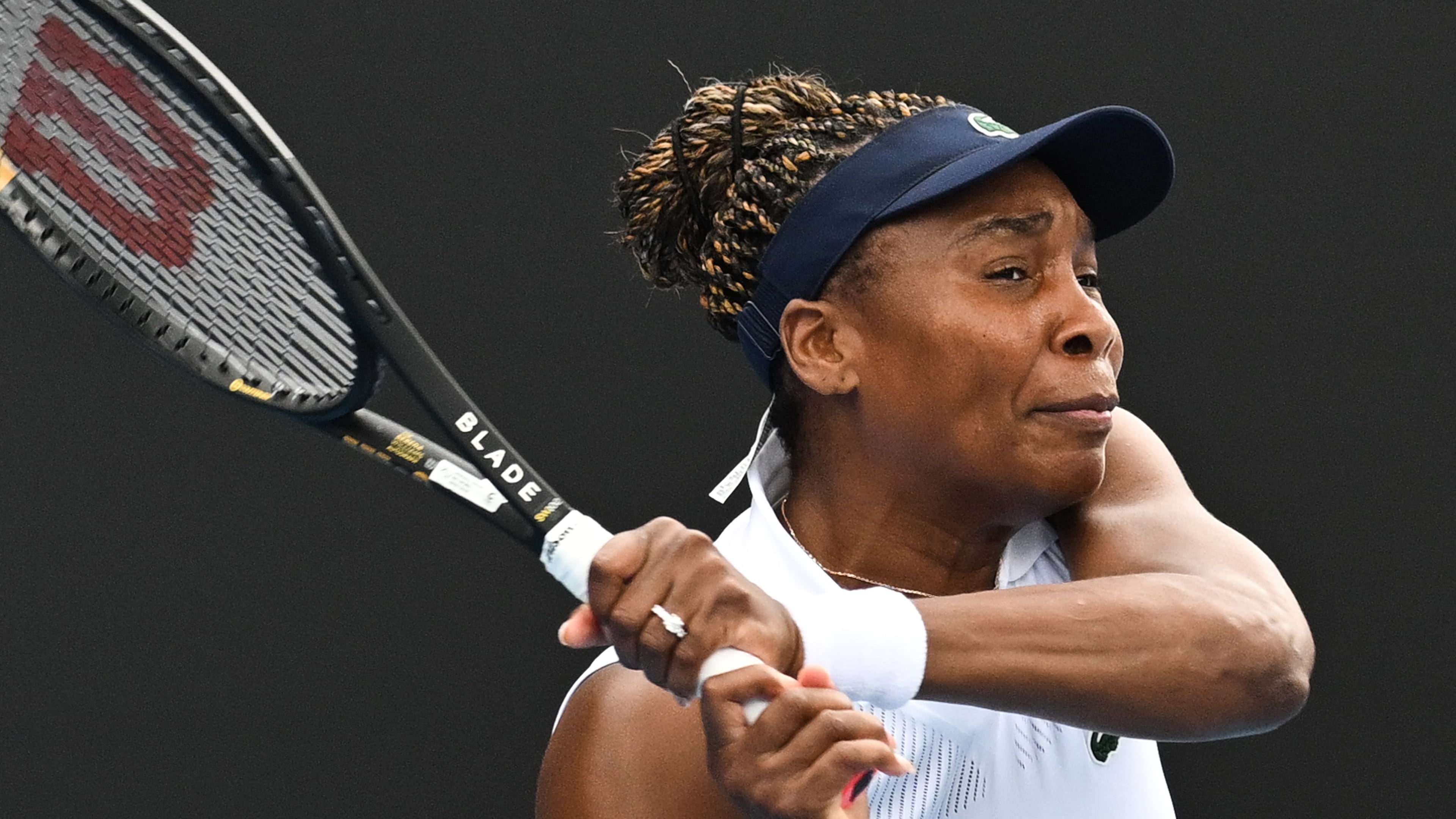 Venus Williams of the U.S. hits a backhand to Magda Linette of Poland during her singles match of the ASB Classic Women's Tennis Tournament in Auckland, New Zealand, Tuesday Jan. 6, 2026. (Andrew Cornaga/Photosport via AP)