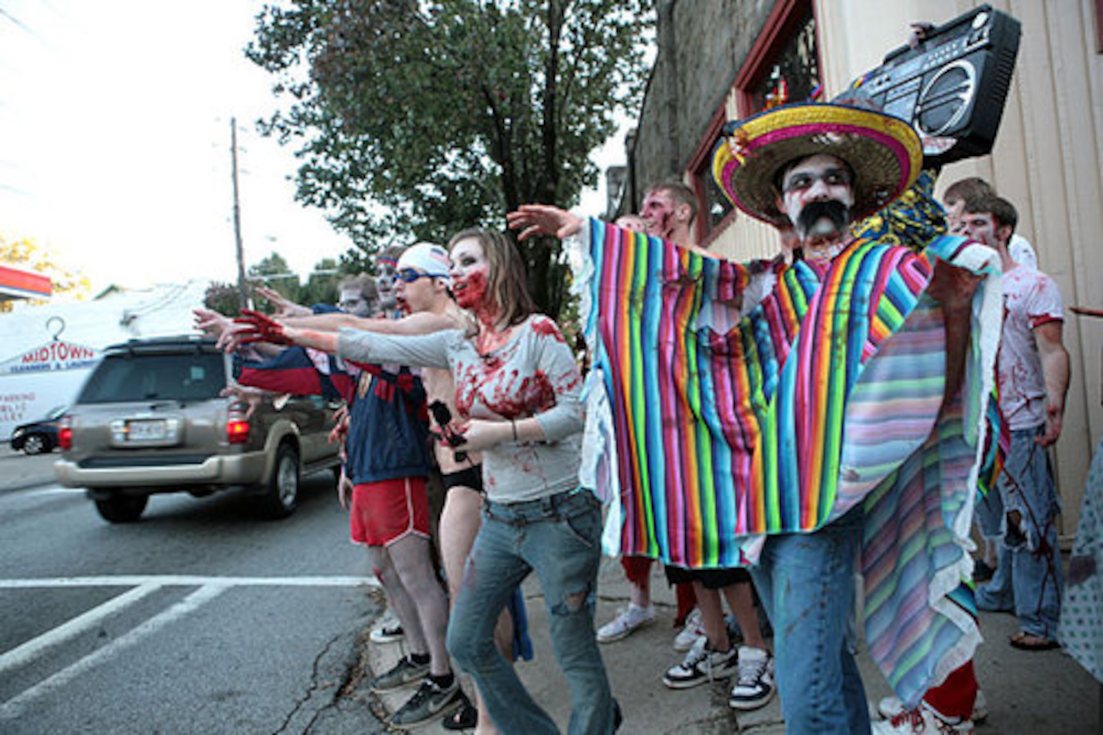 Max Corwell of Atlanta (right) walks along North Avenue and tries to put a scare into traffic during the Zombie Walk from the Masquerade nightclub on Sunday, Oct. 26, 2008.