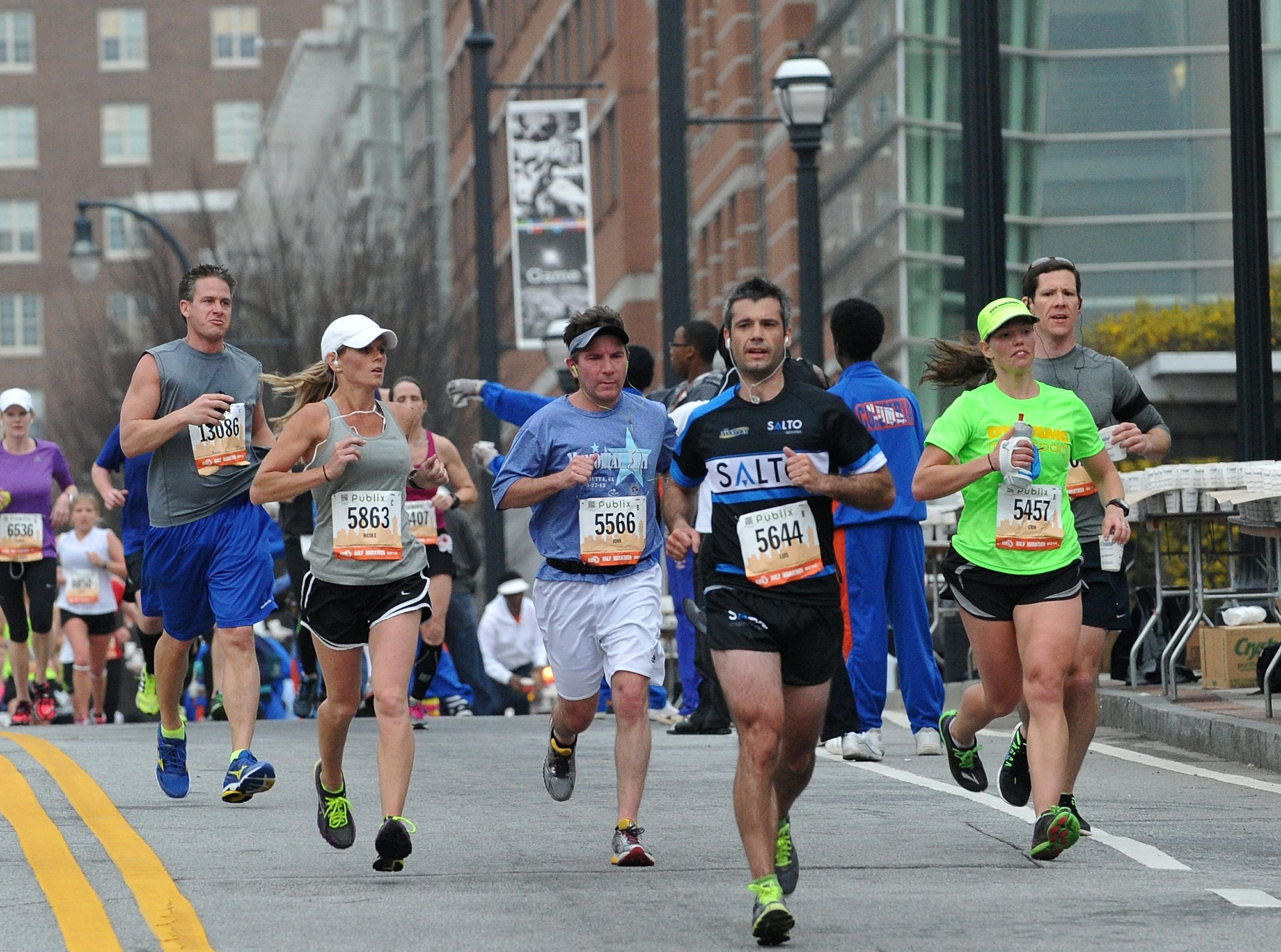 Runners make their way down 5th Street near Georgia Tech for the Publix Georgia Marathon & Half Marathon, Sunday, March 23, 2014, in Atlanta. David Tulis / AJC Special
