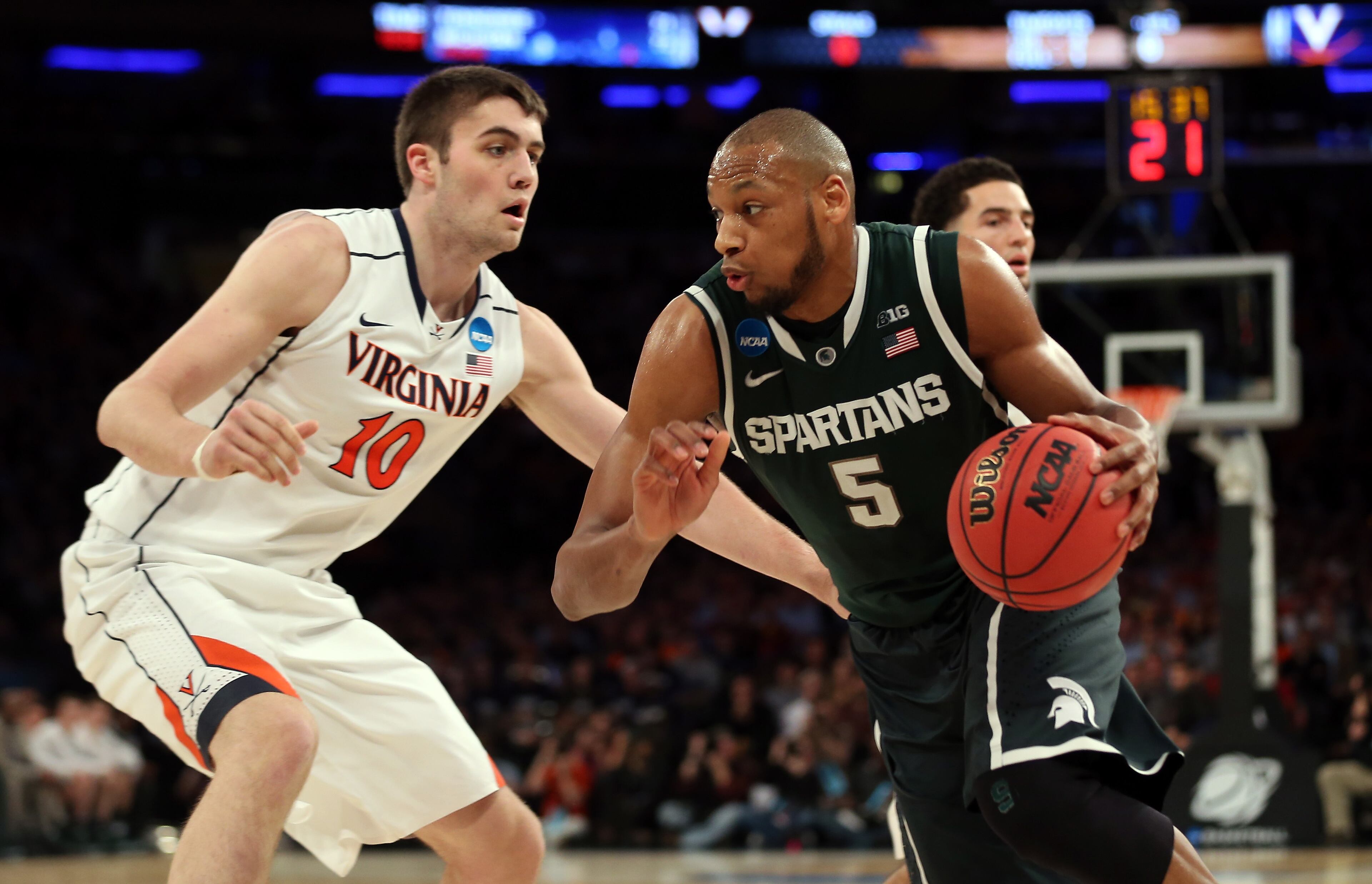 Adreian Payne #5 of the Michigan State Spartans handles the ball against Mike Tobey #10 of the Virginia Cavaliers during the regional semifinal of the 2014 NCAA Men's Basketball Tournament at Madison Square Garden on March 28, 2014 in New York City. (Photo by Bruce Bennett/Getty Images)